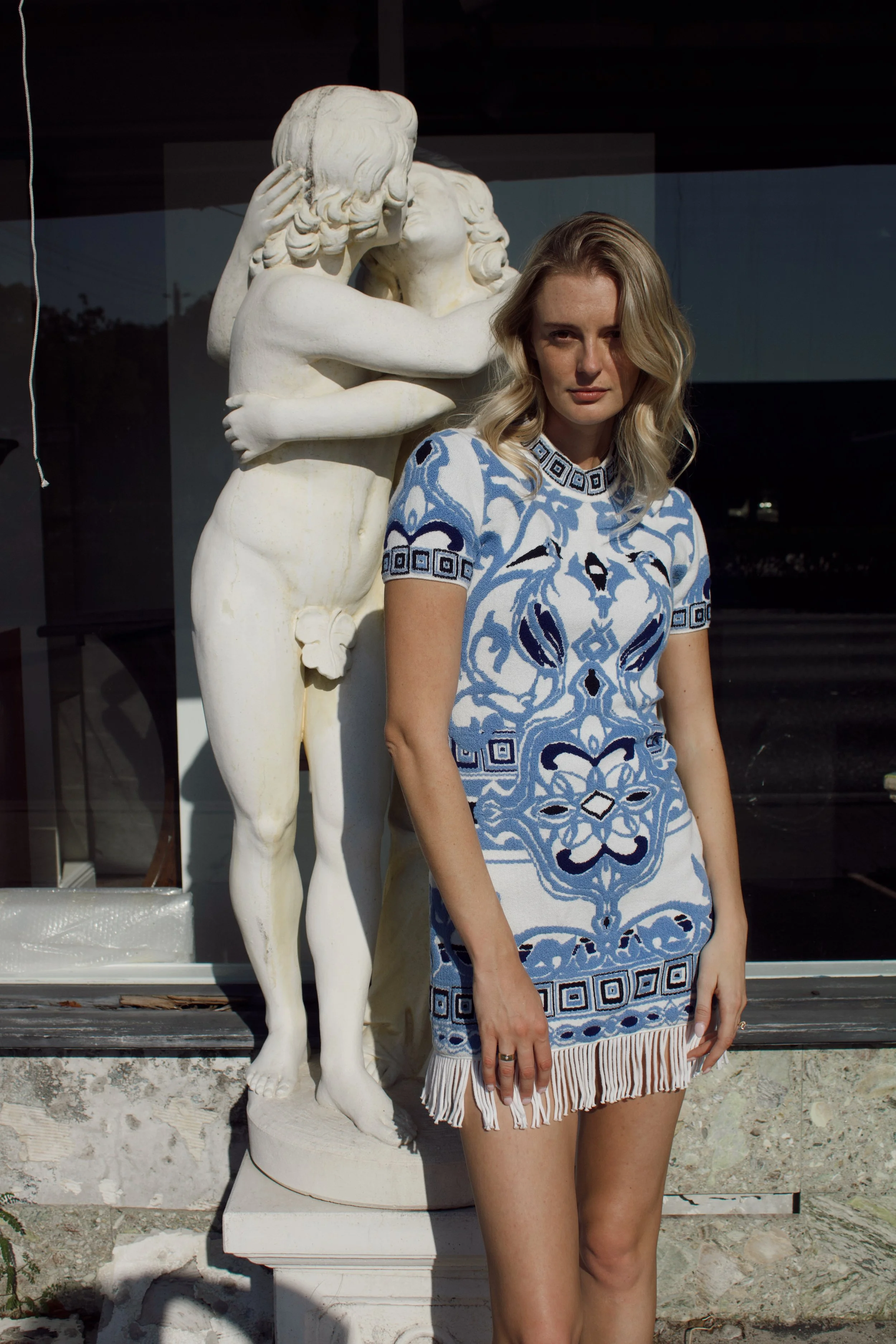 editorial fashion photoshoot featuring a model wearing an emilio pucci dress in front of an italian statue