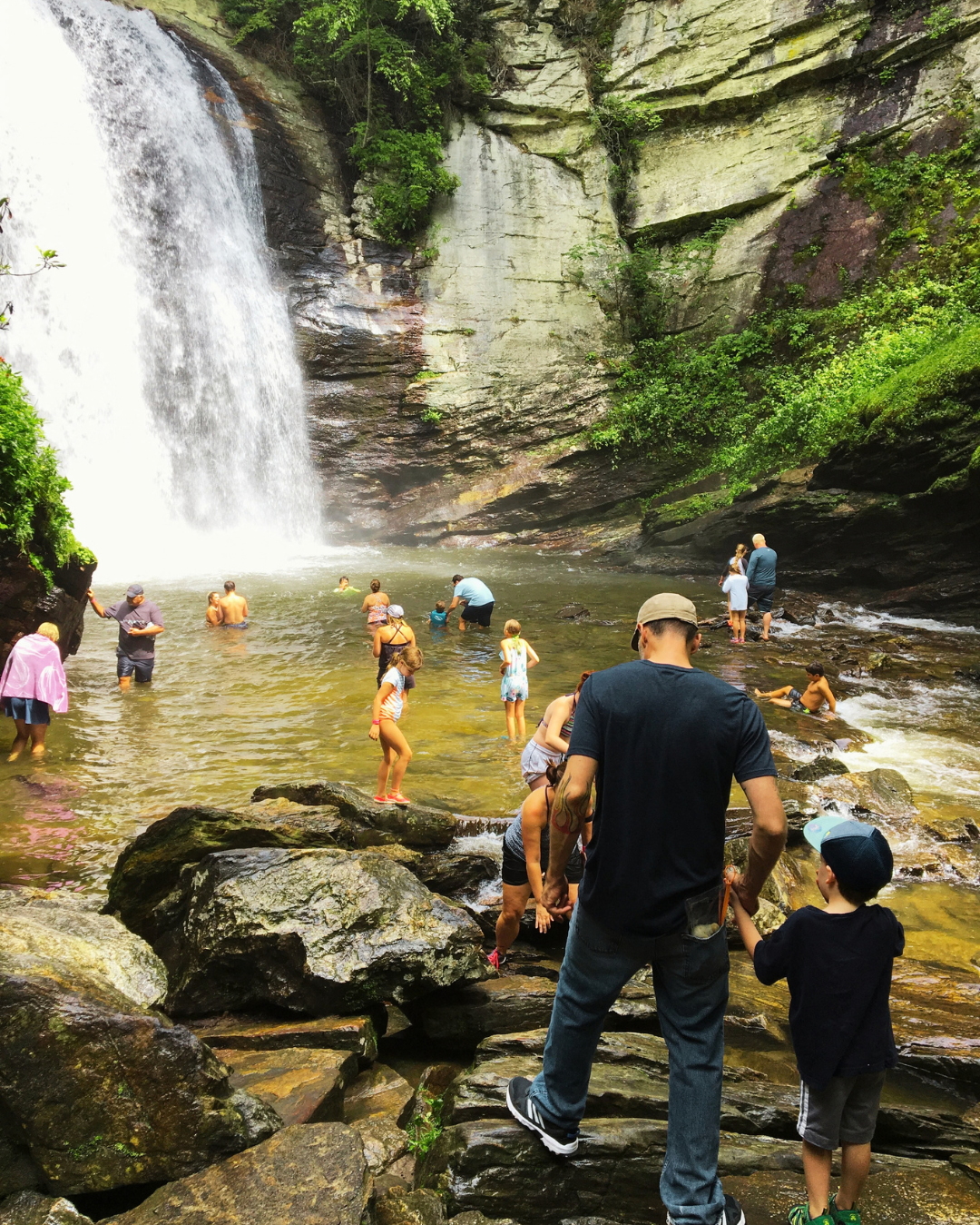 People at base of waterfall