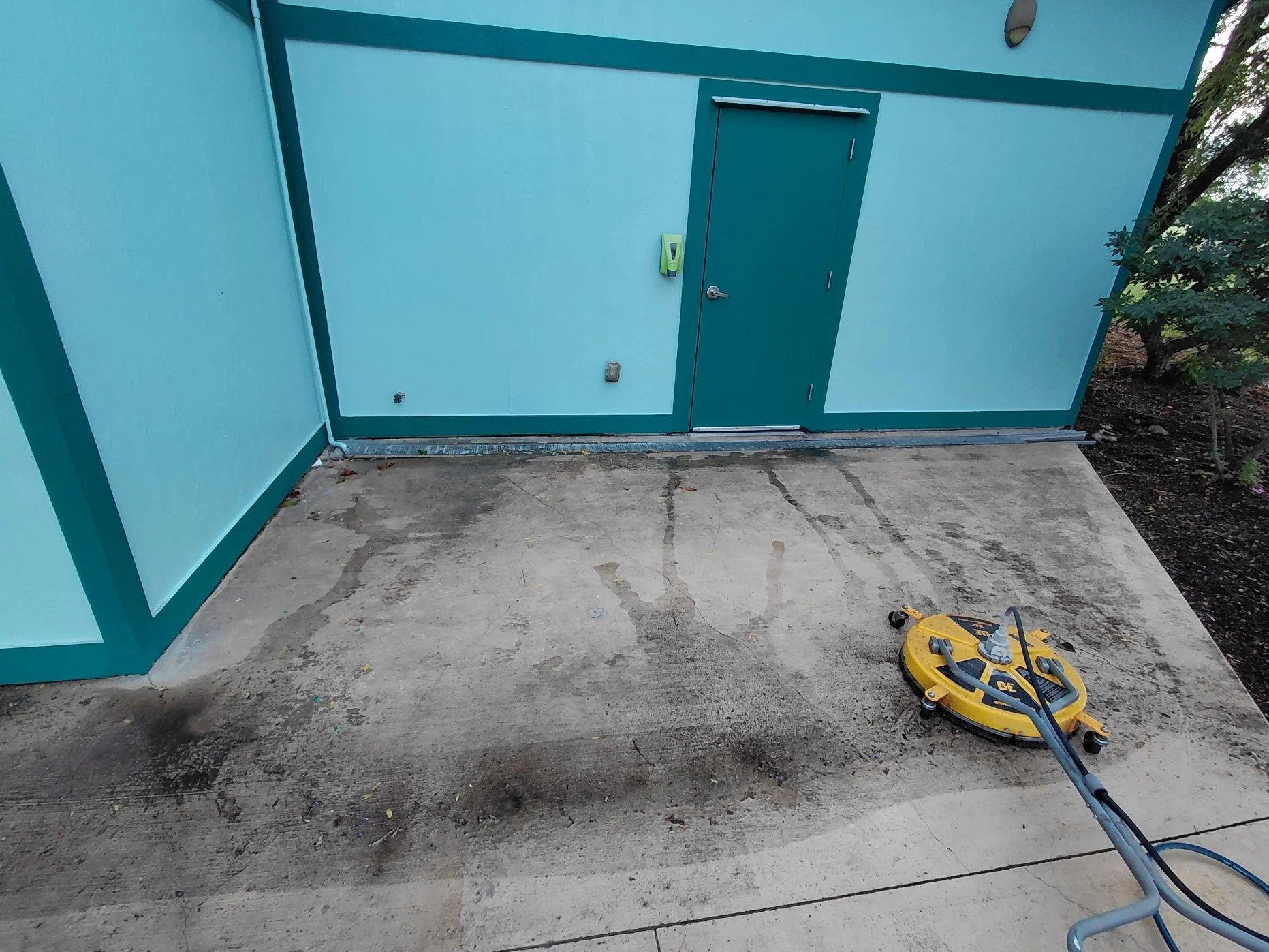 In progress photo of algae, dirt and grime pressure washing at a water park in Roanoke.