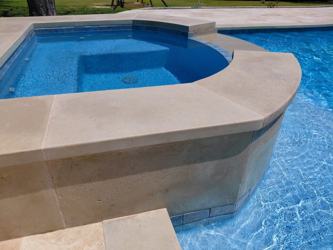 Travertine and coping meeting precisely around the spa