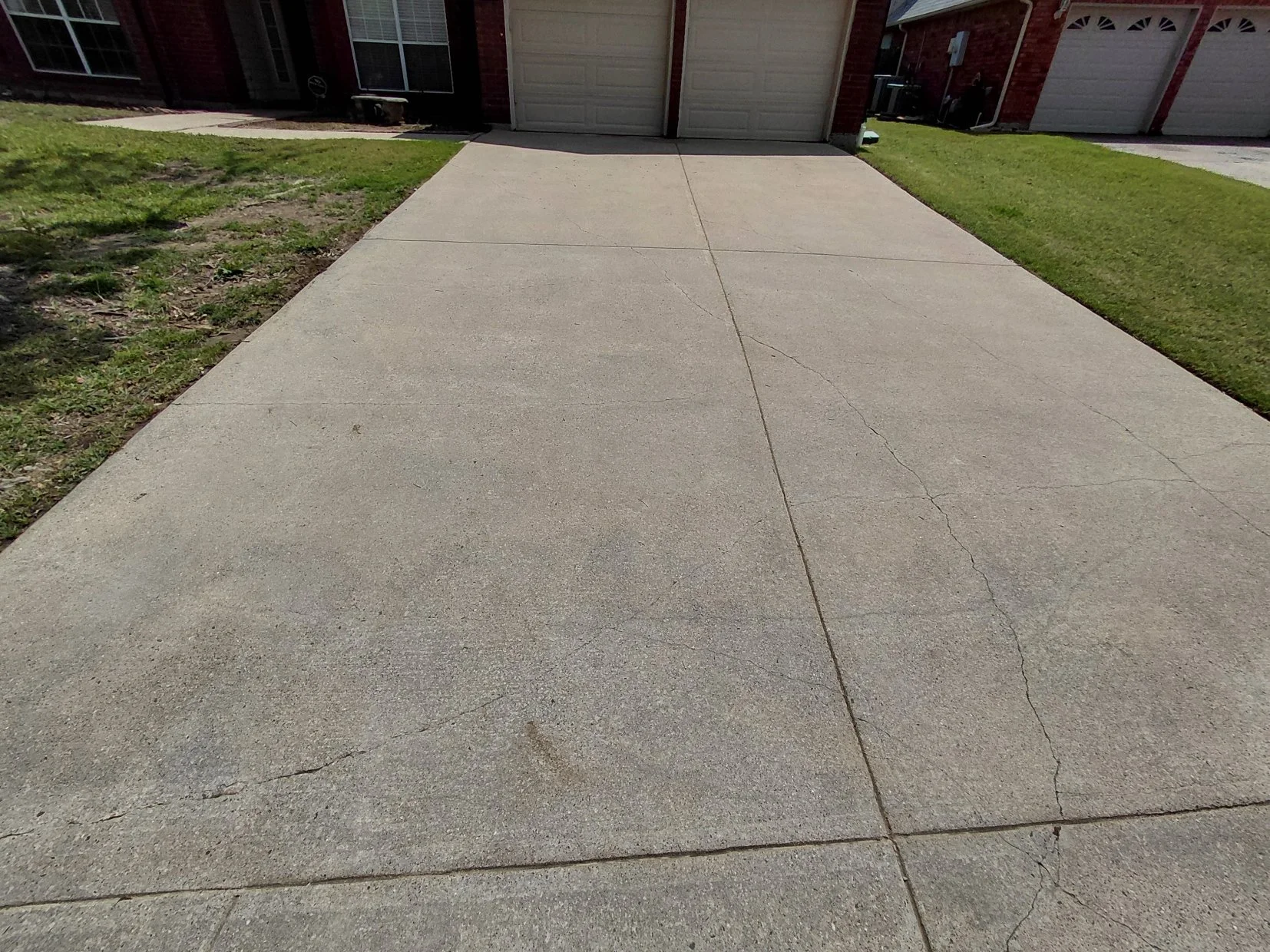 A four car driveway with bright and clean concrete