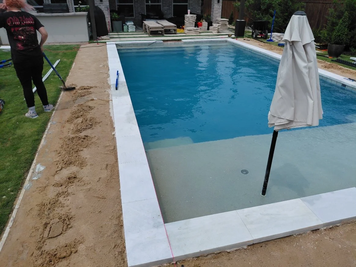 2" bullnose marble coping being installed in Haslet