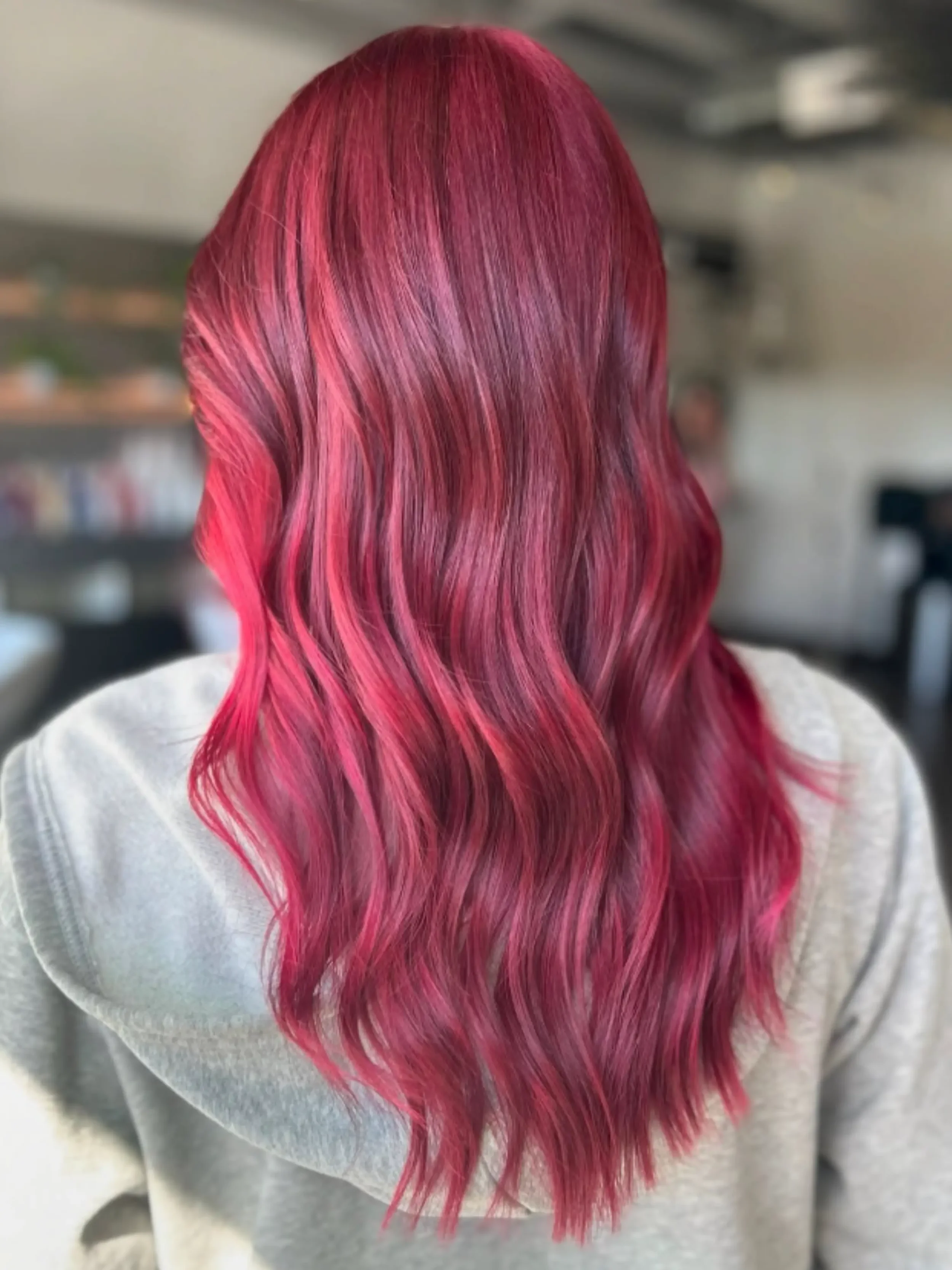Bold magenta and hot-pink hair styled from the back — vivid fashion color at Itsa Salon in Puyallup, WA