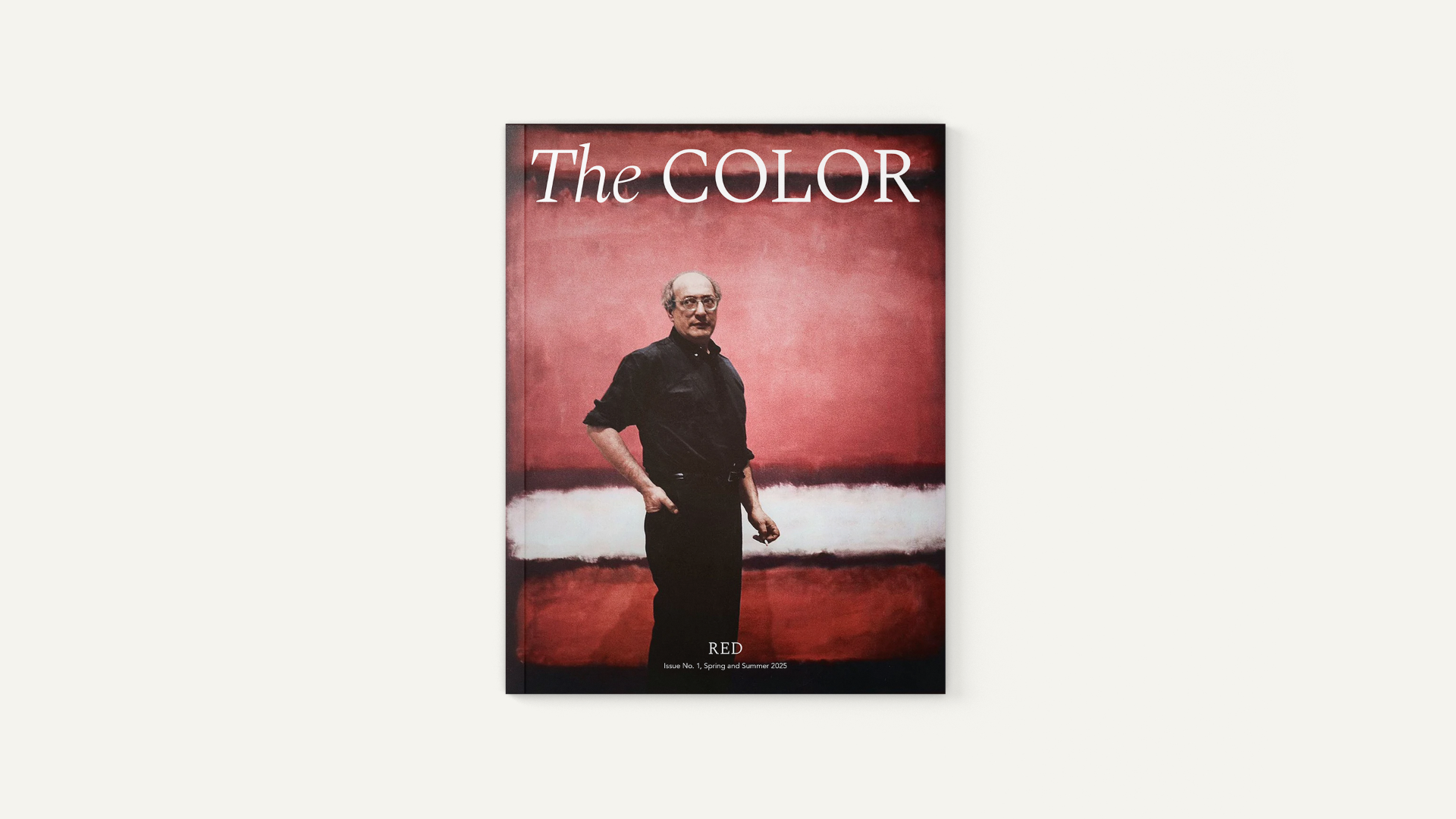 Magazine cover titled "The COLOR" with a man standing in front of a red background, wearing black clothing and glasses, with the word "RED" and issue details at the bottom.