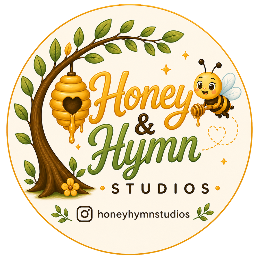 Honey & Hymn Studios children's book publisher logo featuring a smiling bee holding a honey dipper, a golden beehive hanging from a leafy tree, and the brand name in gold and green lettering.
