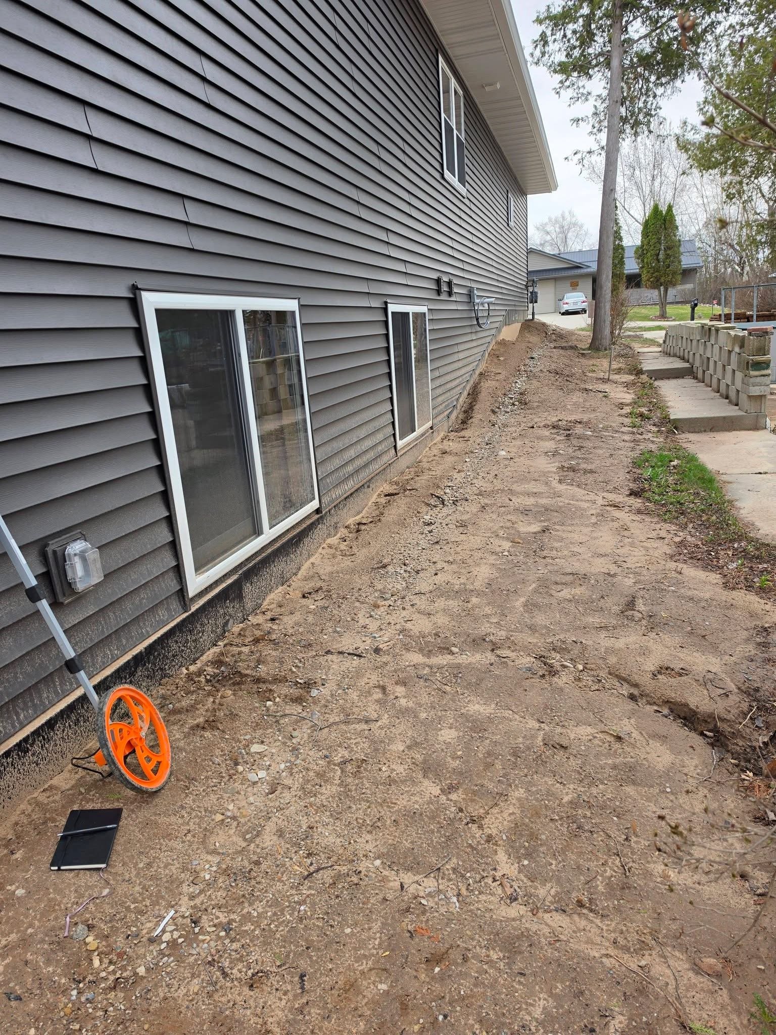 Side yard — Ground prep and grading along house foundation by Ground & Grid Solutions Northeast Wisconsin