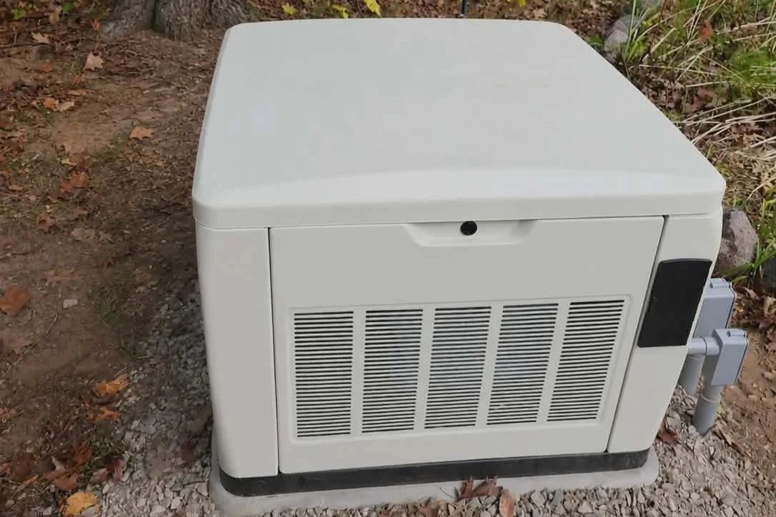 Generator on pad — Standby home generator installed on gravel pad by Ground & Grid Solutions in Northeast Wisconsin
