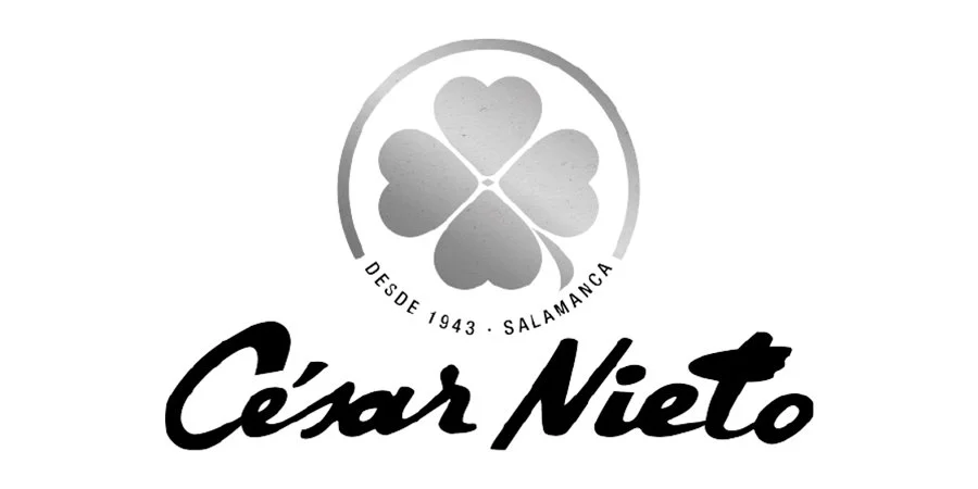 Black and white logo with a four-leaf clover inside a circle and the text 'Desde 1943 Salamanca' below it. The name 'César Nieto' is written in bold, cursive font at the bottom.