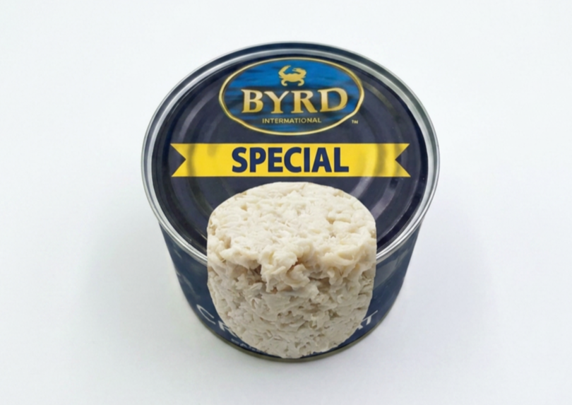 Canned Byrd Special white chicken spread with a portion scooped out, against a white background.