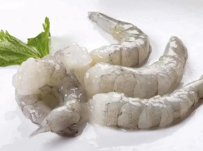 Vietnam Tiger Prawn Meat/Raw shrimp with a green garnish on a white background.