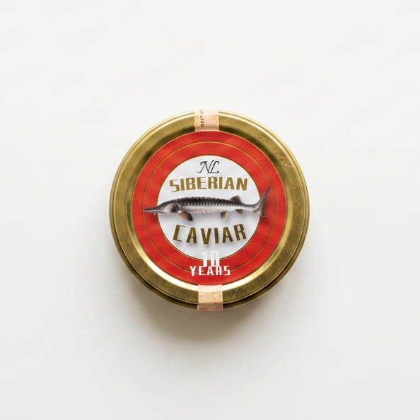 A round tin container labeled "Siberian Caviar" with a fish illustration on the lid, placed on a white surface.