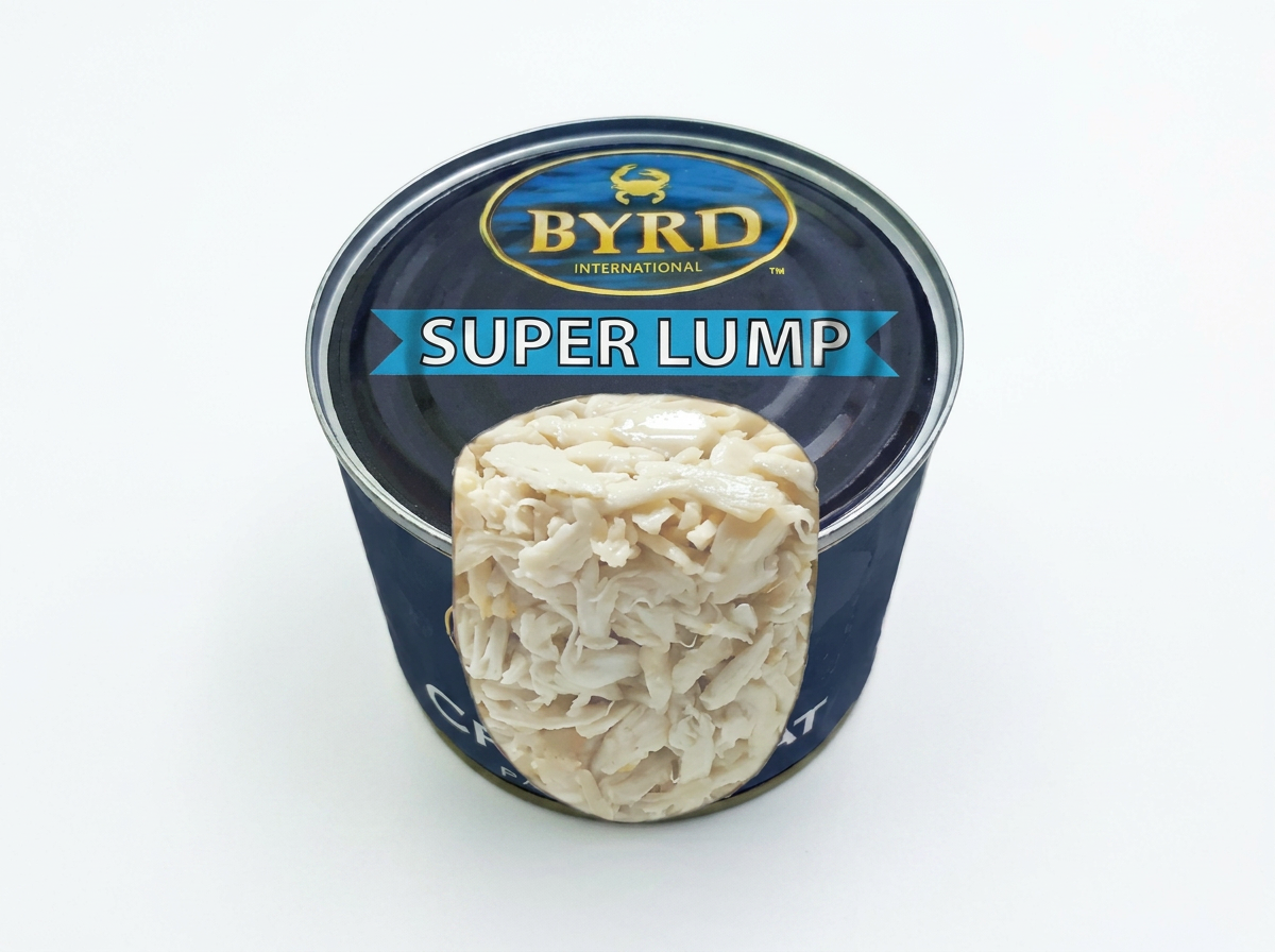 A can of BYRD Super Lump crab meat with a piece of crab meat placed in front of it on a white surface.