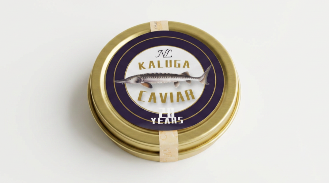 Round tin container of Kaluga caviar with a fish illustration on the label.
