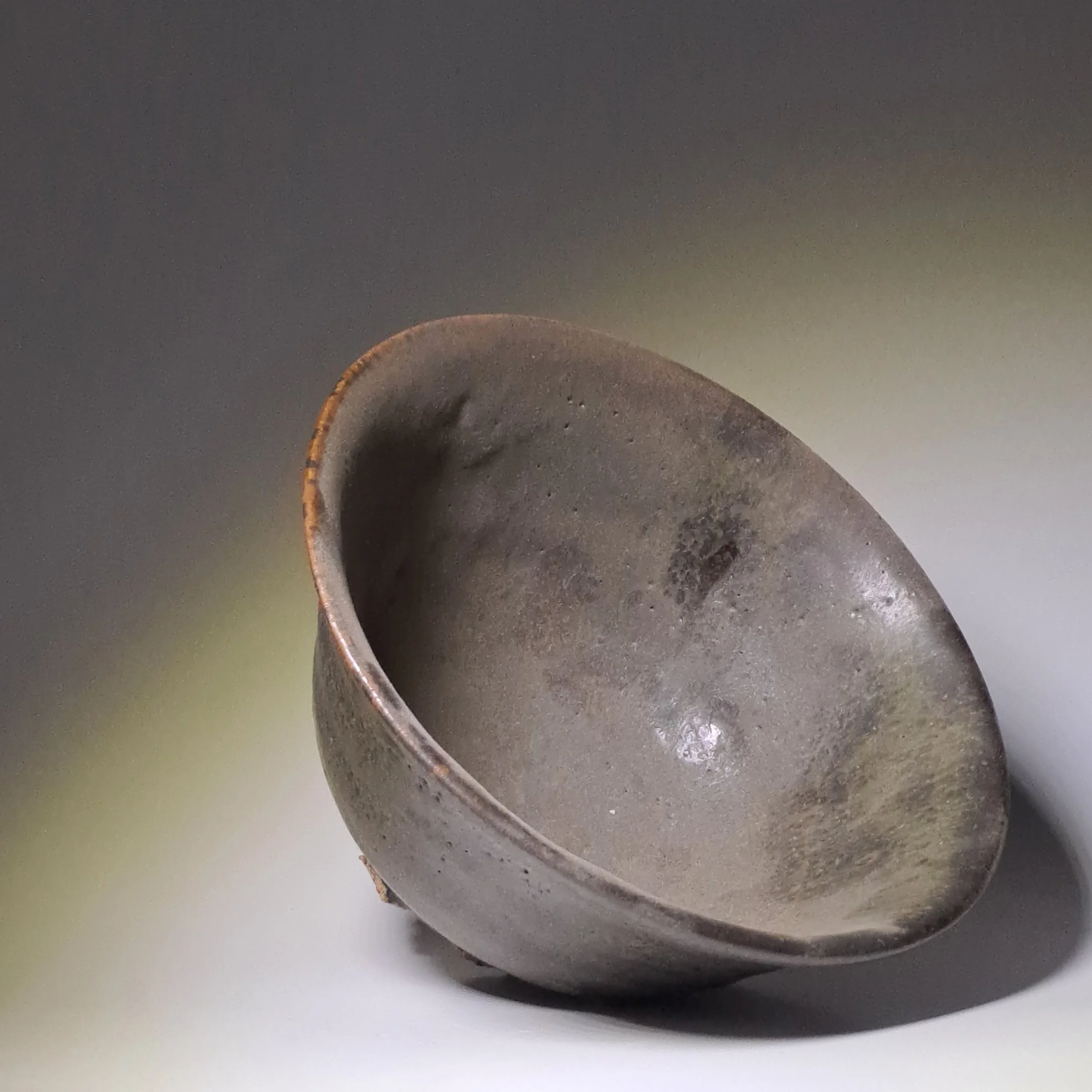A breathtaking black-glazed bowl born from the unpredictable whims of the wood-fired kiln.
