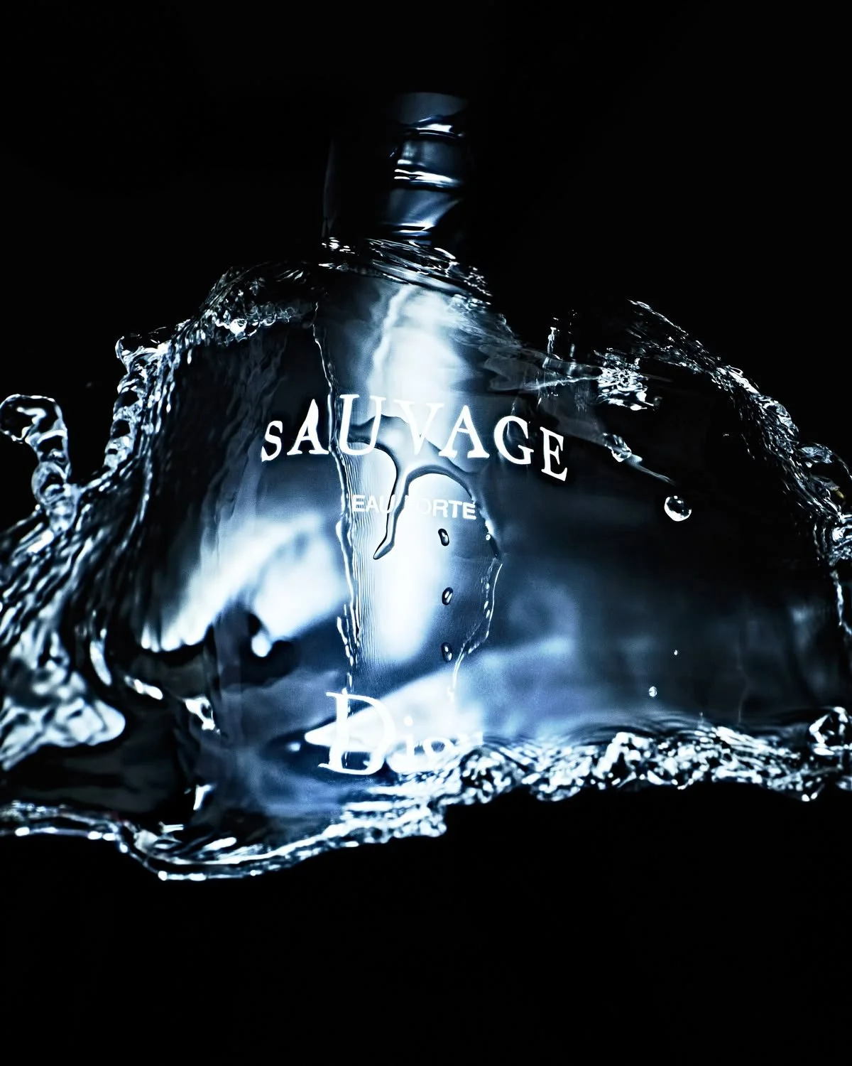Botella de agua con etiquetas que dicen 'SauVage' y 'Eau Forte', rodeada de agua en espuma y gotas, fondo oscuro.
