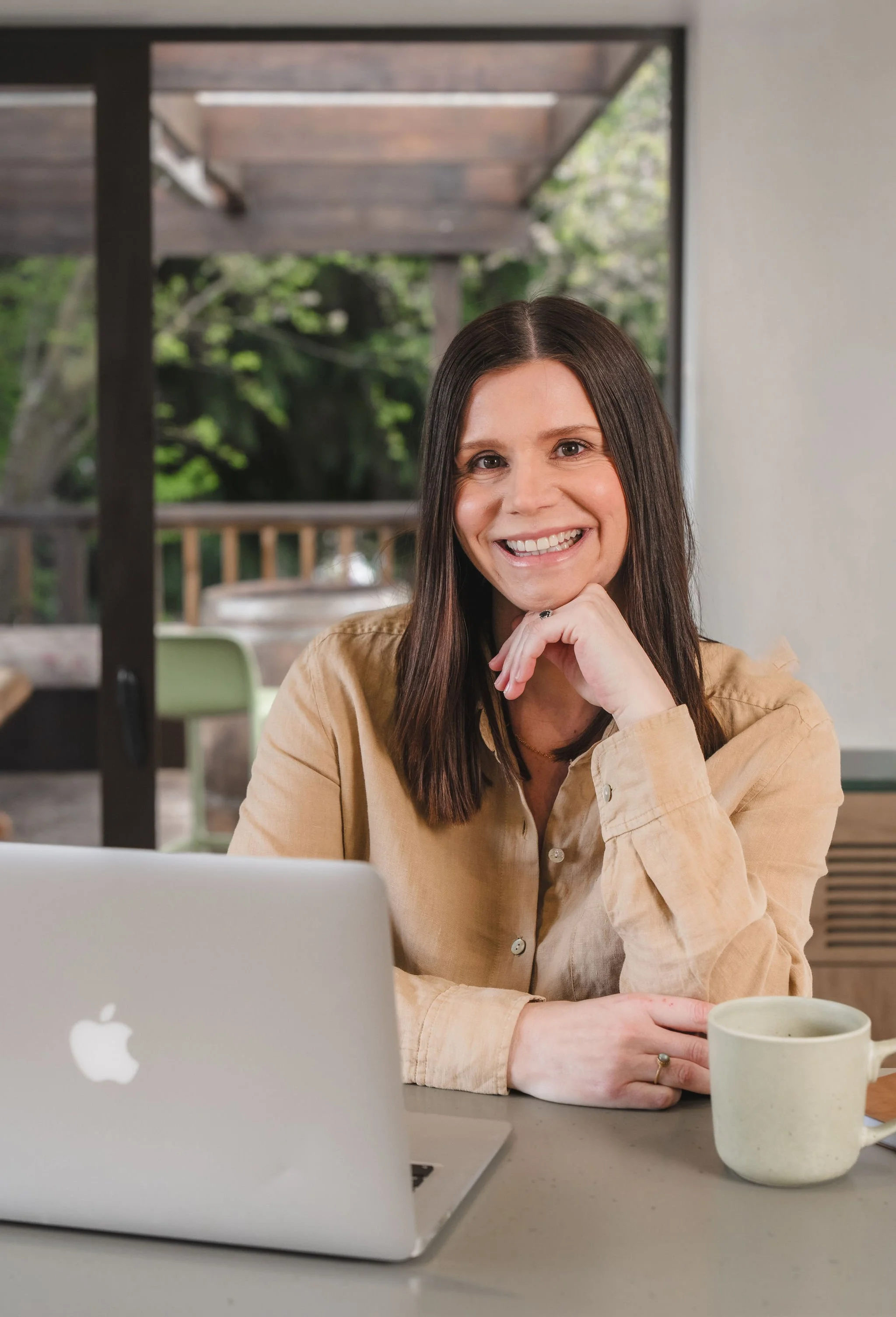 Amy Townsend, Wānaka marketing consultant, smiling at her laptop