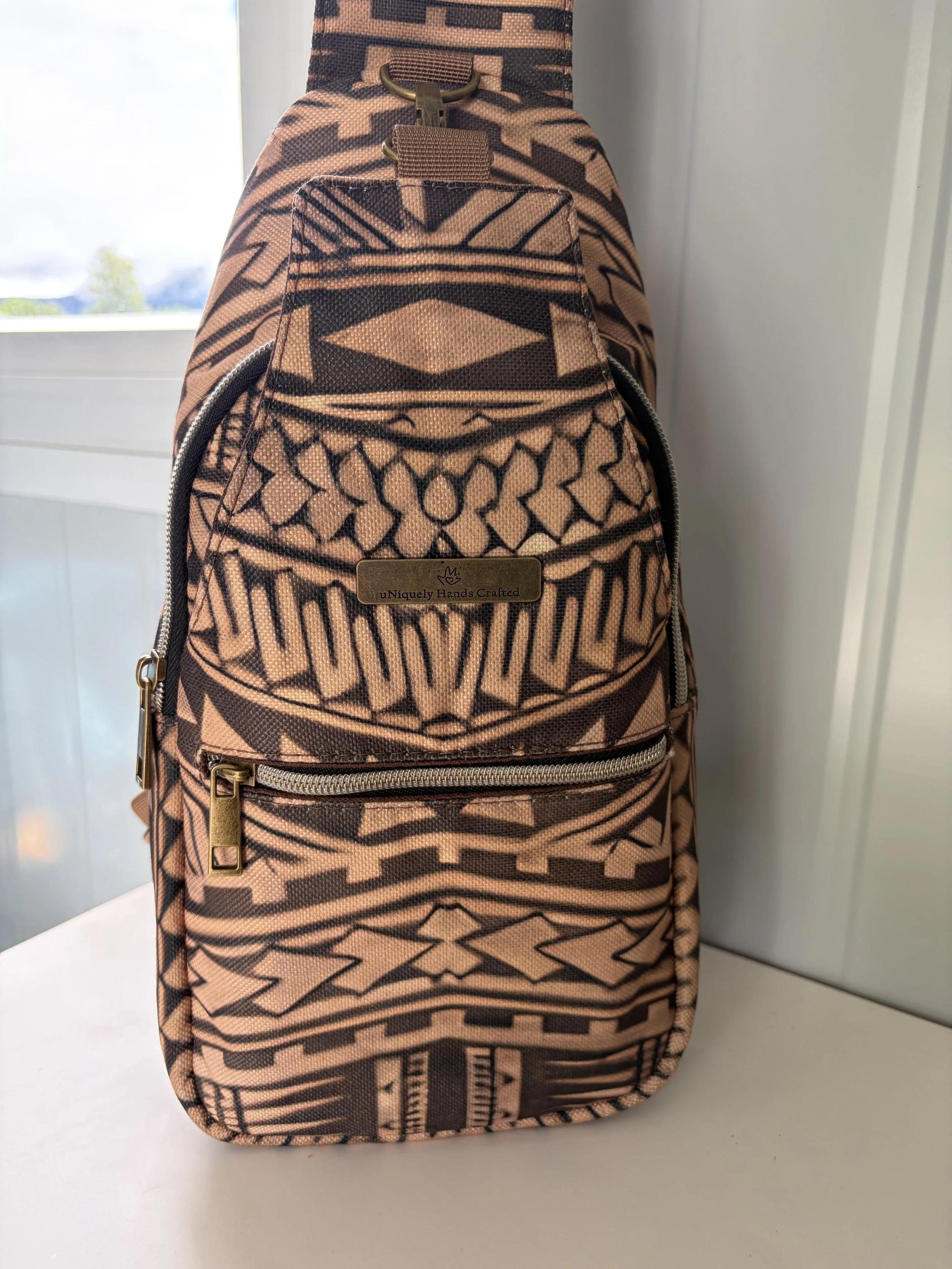 Handcrafted Legacy Re-Crafted backpack created from treasured tapa-inspired fabric, preserving the original pattern and cultural character of the textile.