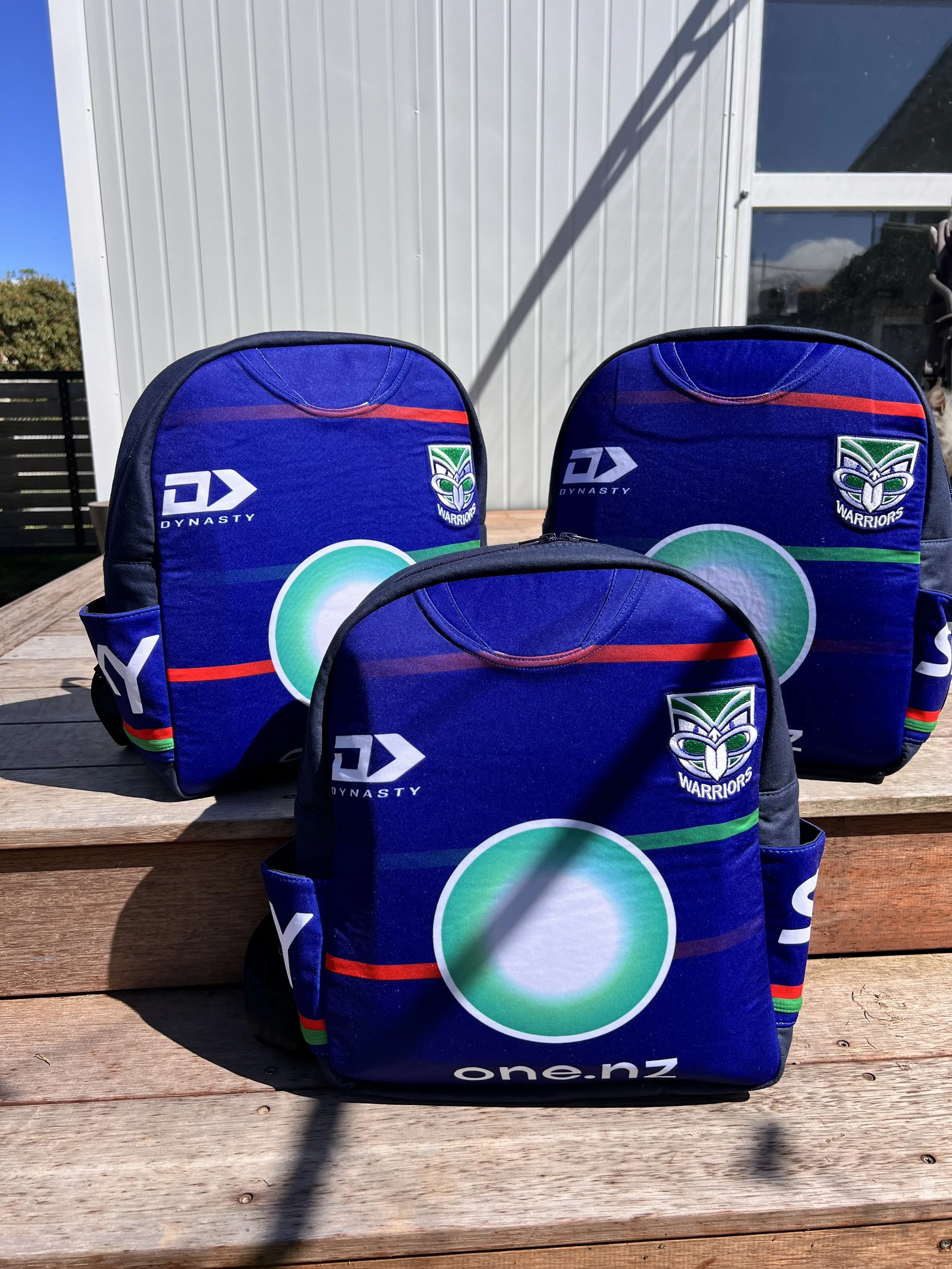 Handcrafted bag created from a treasured New Zealand Warriors rugby league jersey, preserving the original team colours, logos and jersey details