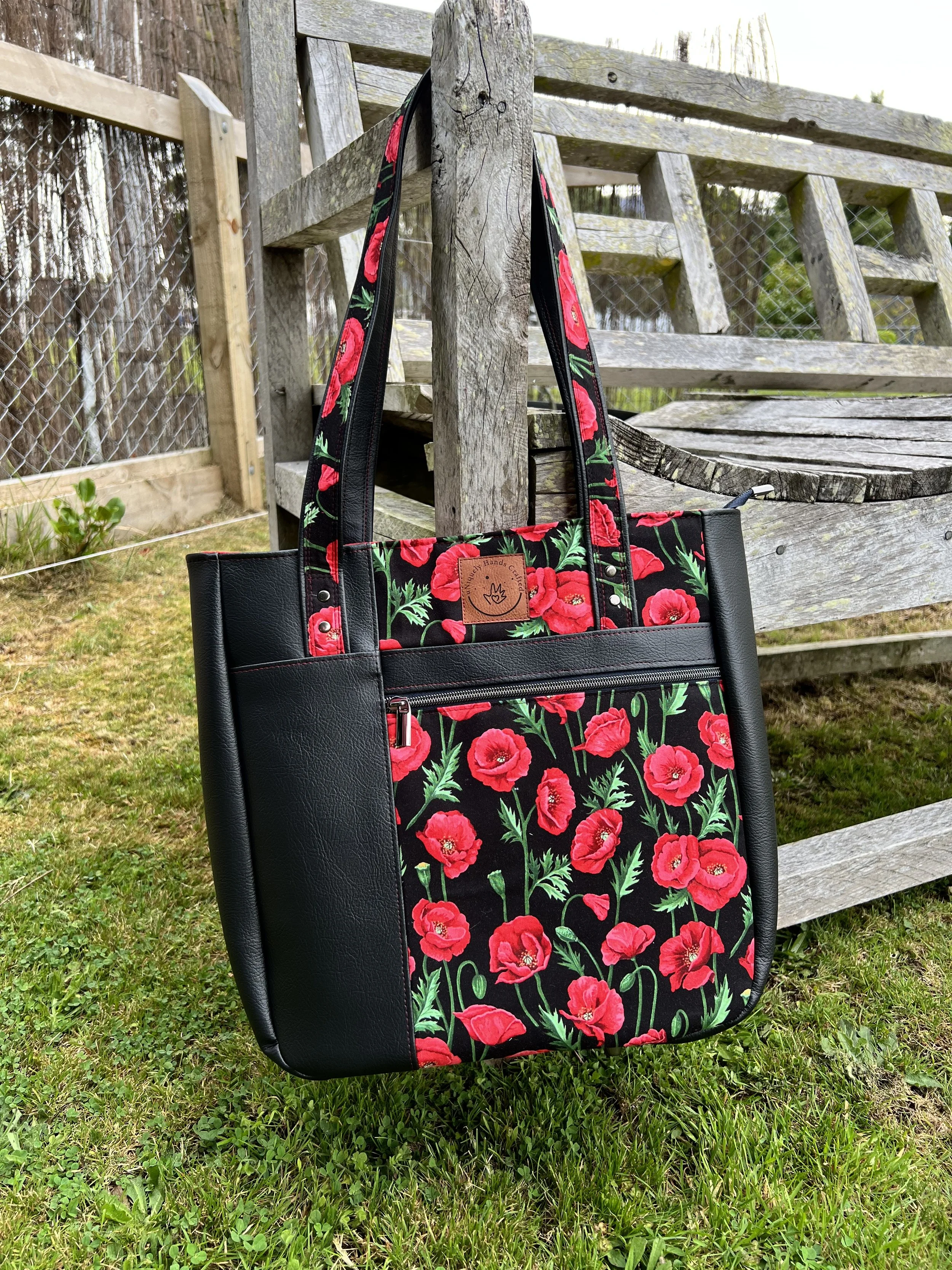 Custom handcrafted bag featuring vibrant poppy fabric with black vinyl, from the uNiquely Hands Crafted Collection.