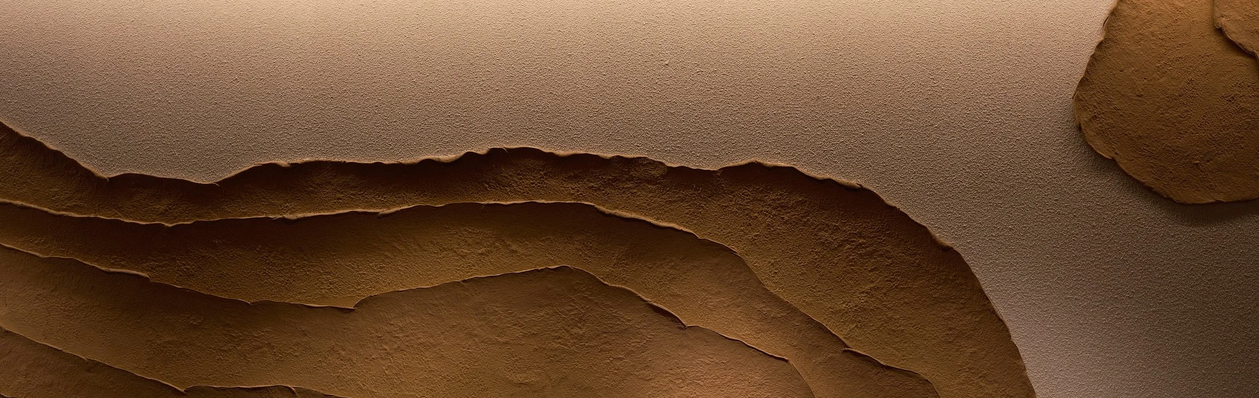 Close-up of torn paper edges revealing layers underneath.