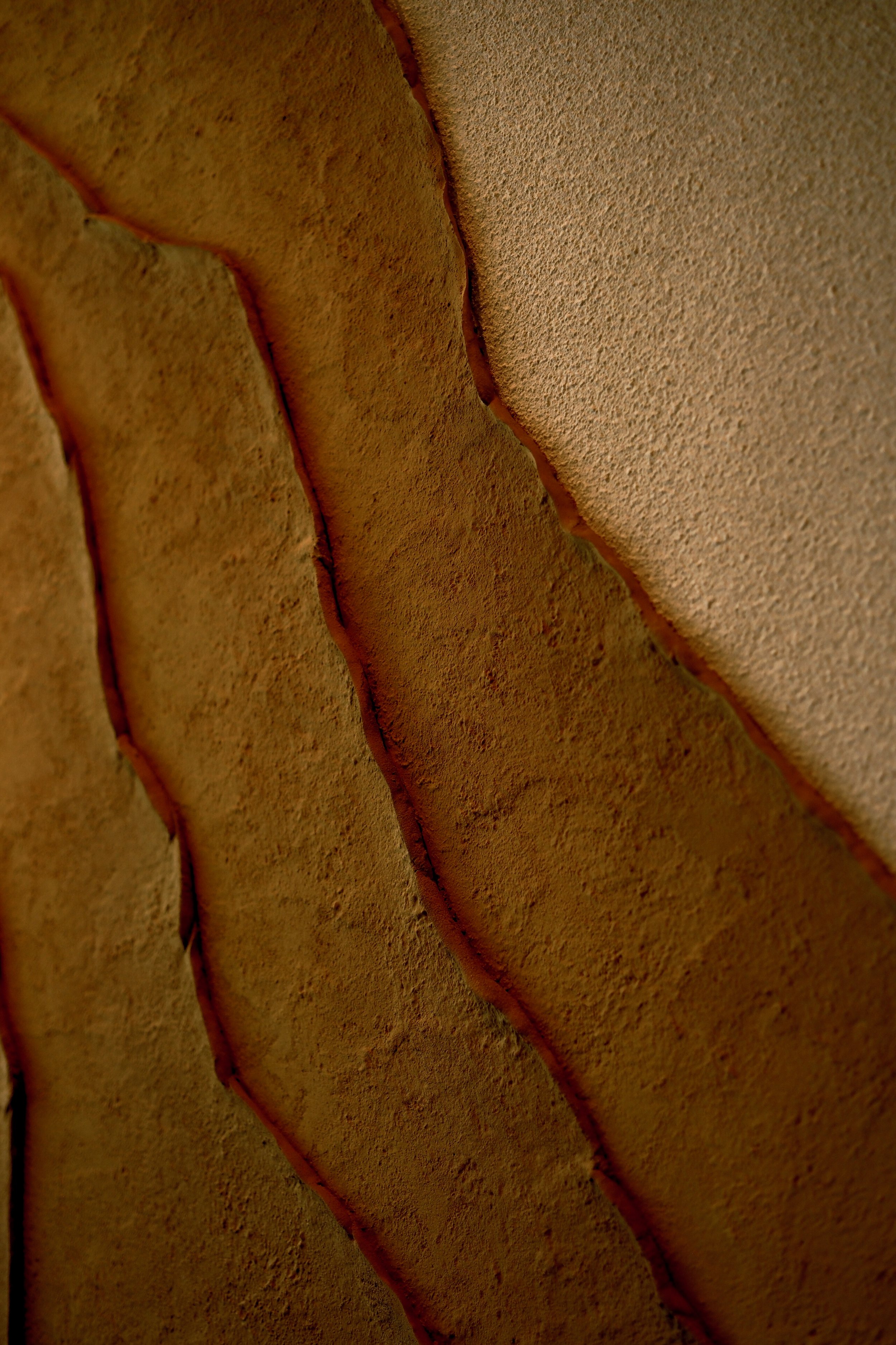 Close-up view of a leather or faux leather surface with stitched seams.