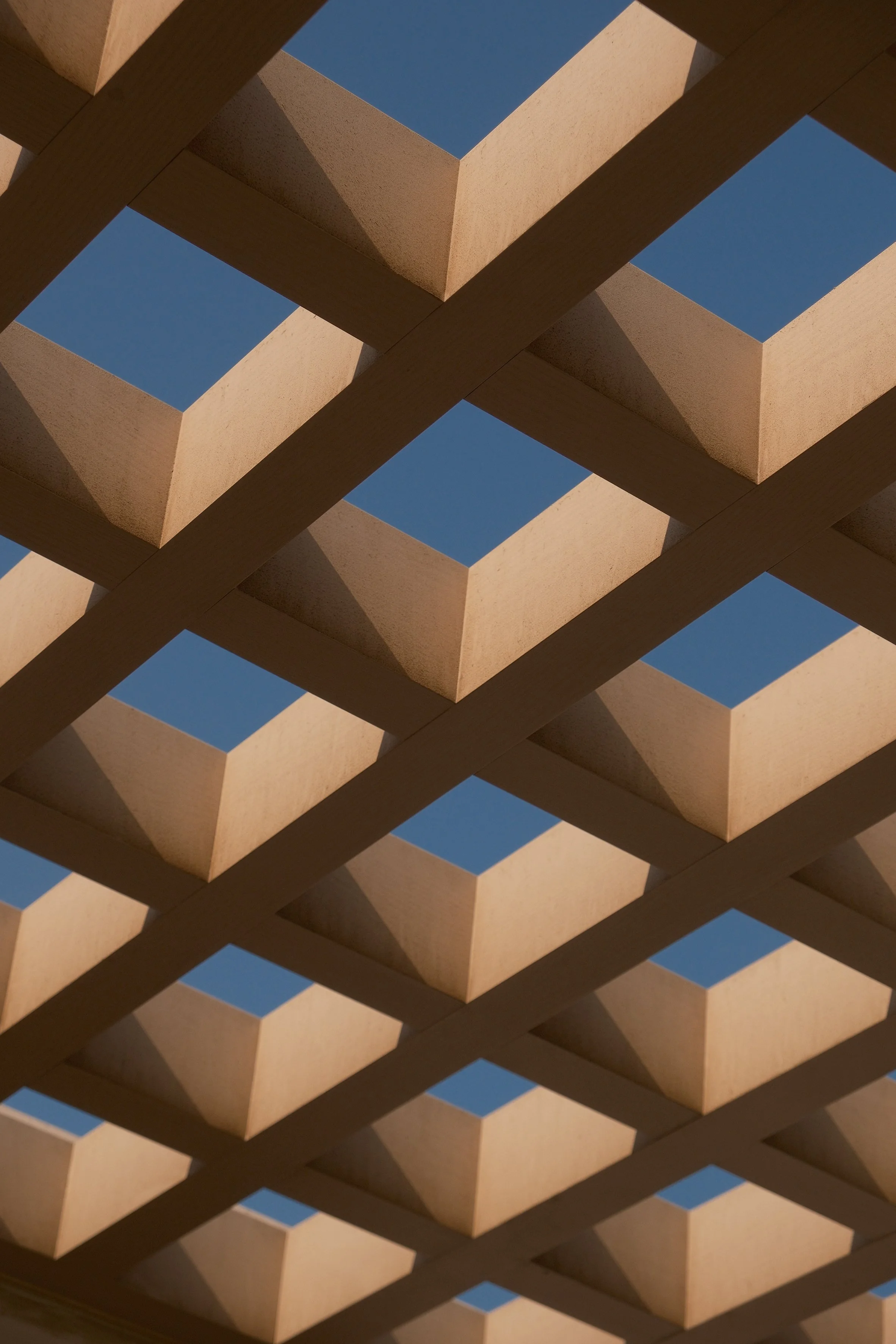 Close-up of a wooden lattice structure against the sky.