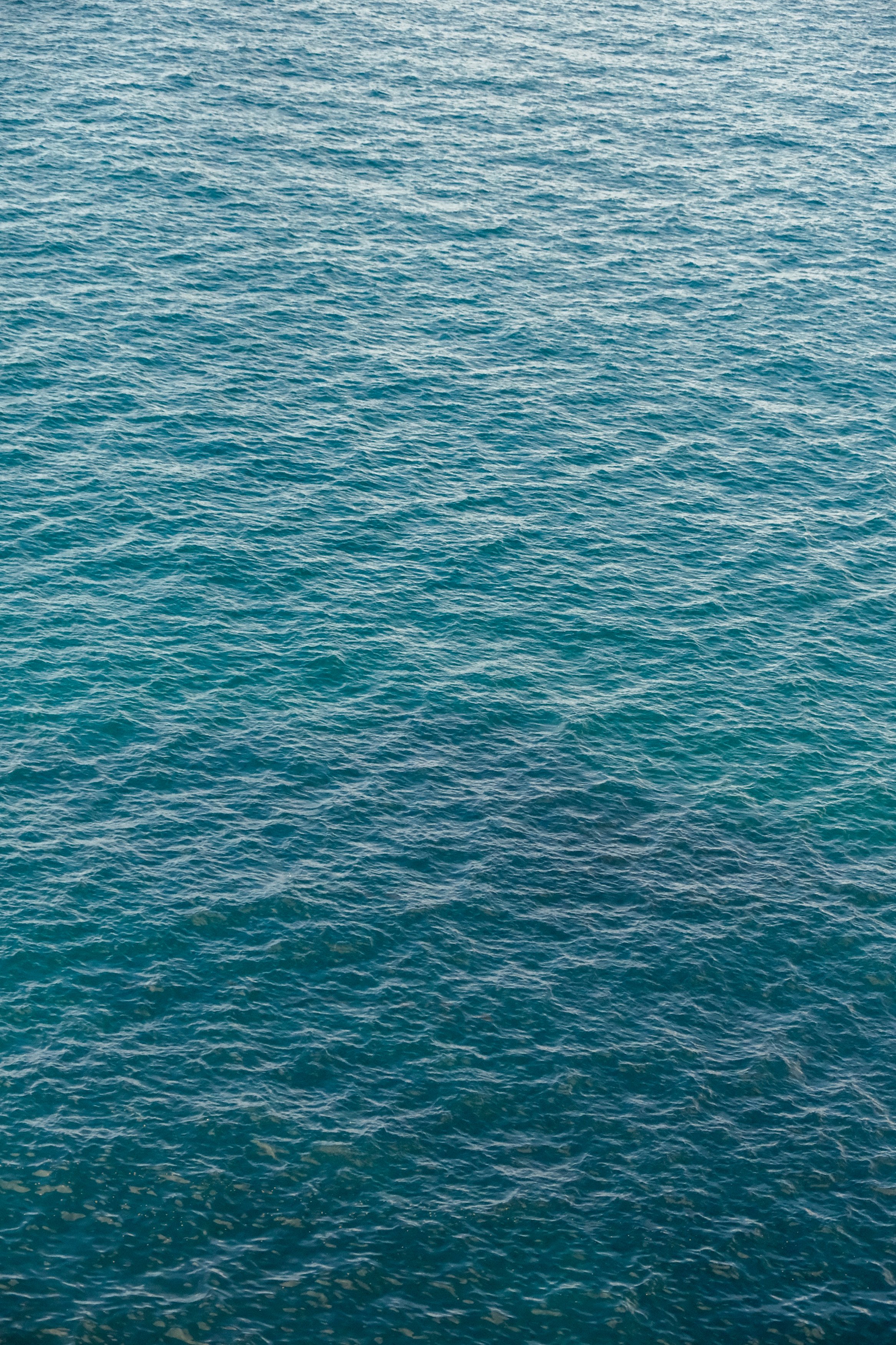 A large body of blue water with small waves and ripples.