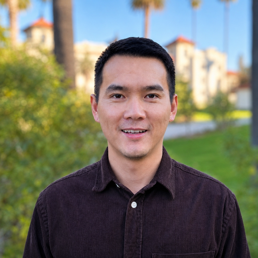 Professional outdoor headshot of Dr. Chongzheng (Francis) Wei smiling, wearing a dark button-down shirt, with a blurred campus landscape in the background