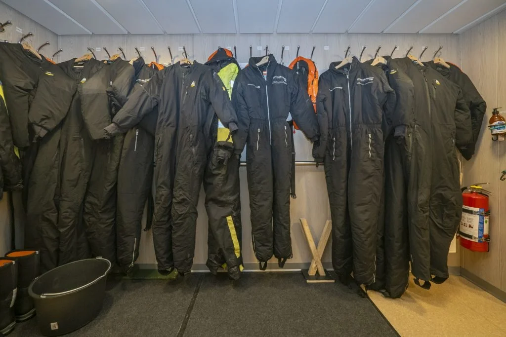 Expedition drysuits prepared for cold-water wildlife photography in Northern Norway.