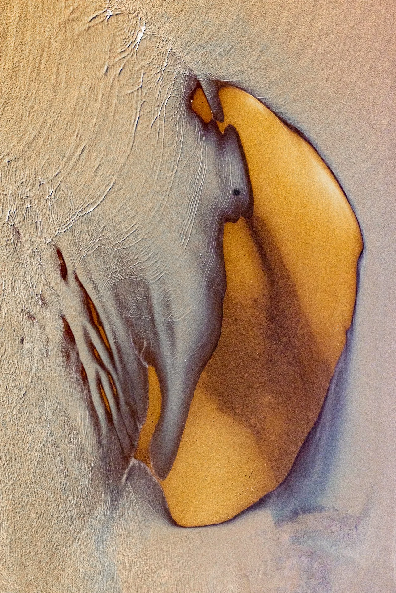 Close-up of a letter 'J' with an artistic and textured background in yellow, gray, and orange hues.