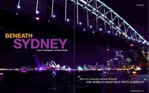 Nighttime view of Sydney Harbour Bridge with city lights in the background. Text overlays read 'Beneath Sydney' and 'Time & Photography by Roni Pahad'.