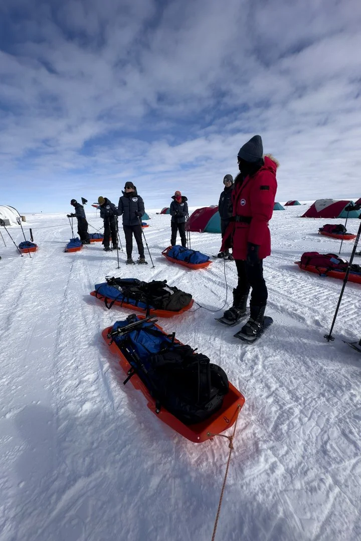 Expedition team preparing sleds for the journey across Antarctica to the emperor penguin colony.