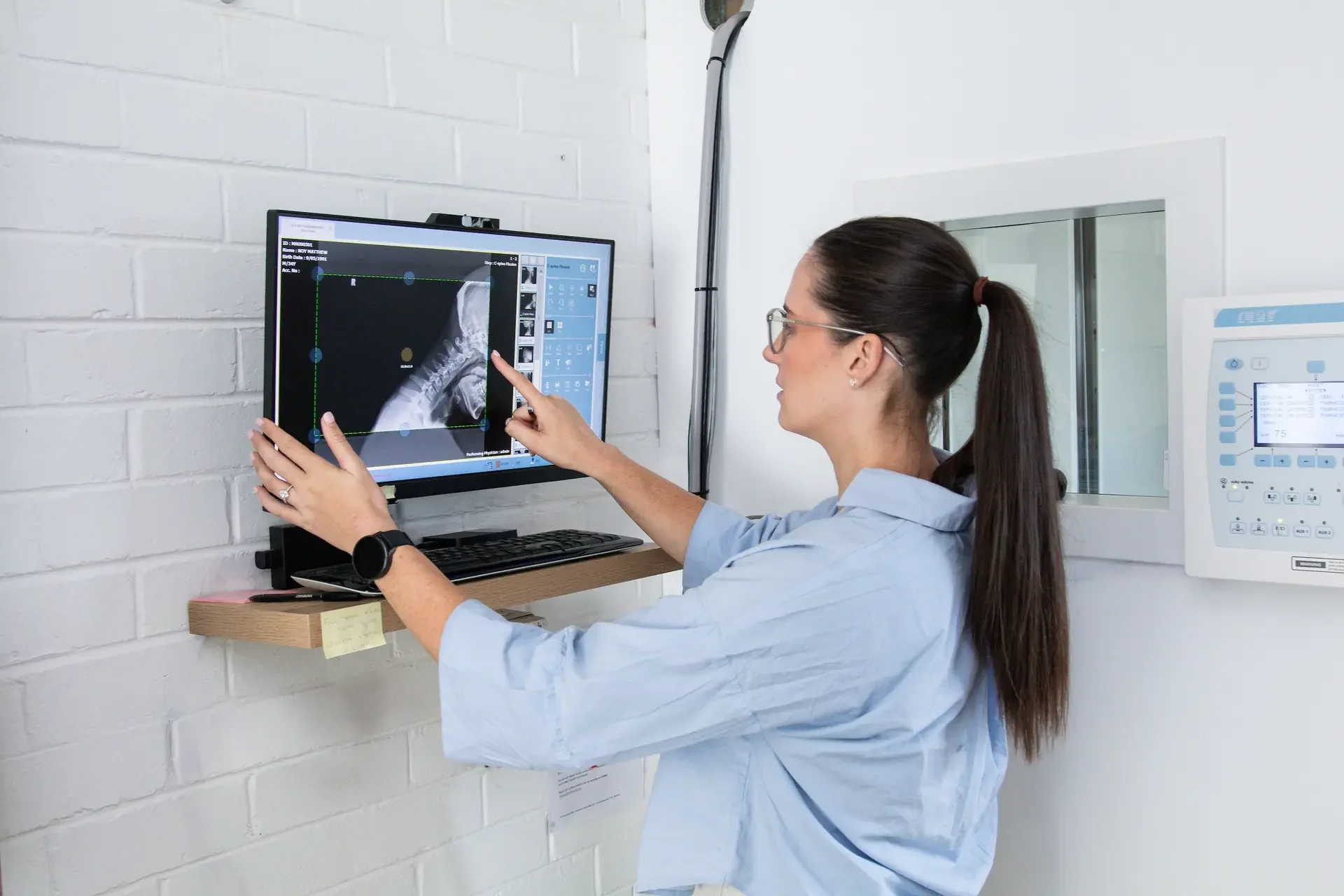 Dr Tia Deoki chiropractor reviewing X-ray images