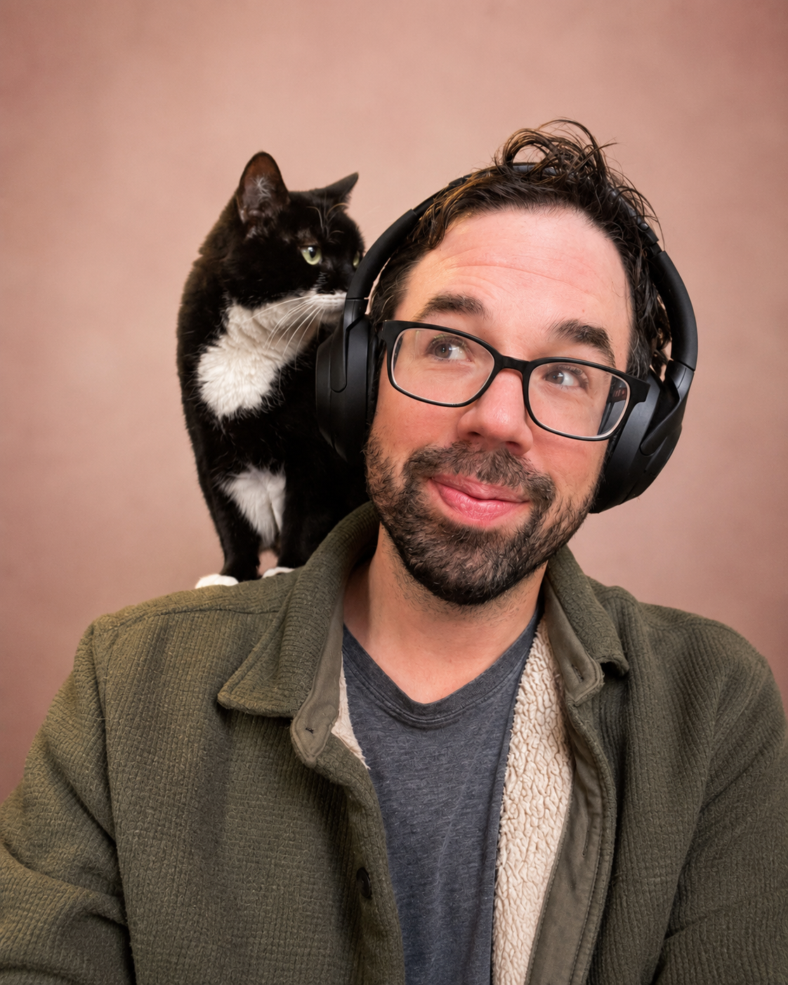 Portrait of Brett Tunick, illustrator and visual storytelling lead at Story Bound, with his cat Chickpea.