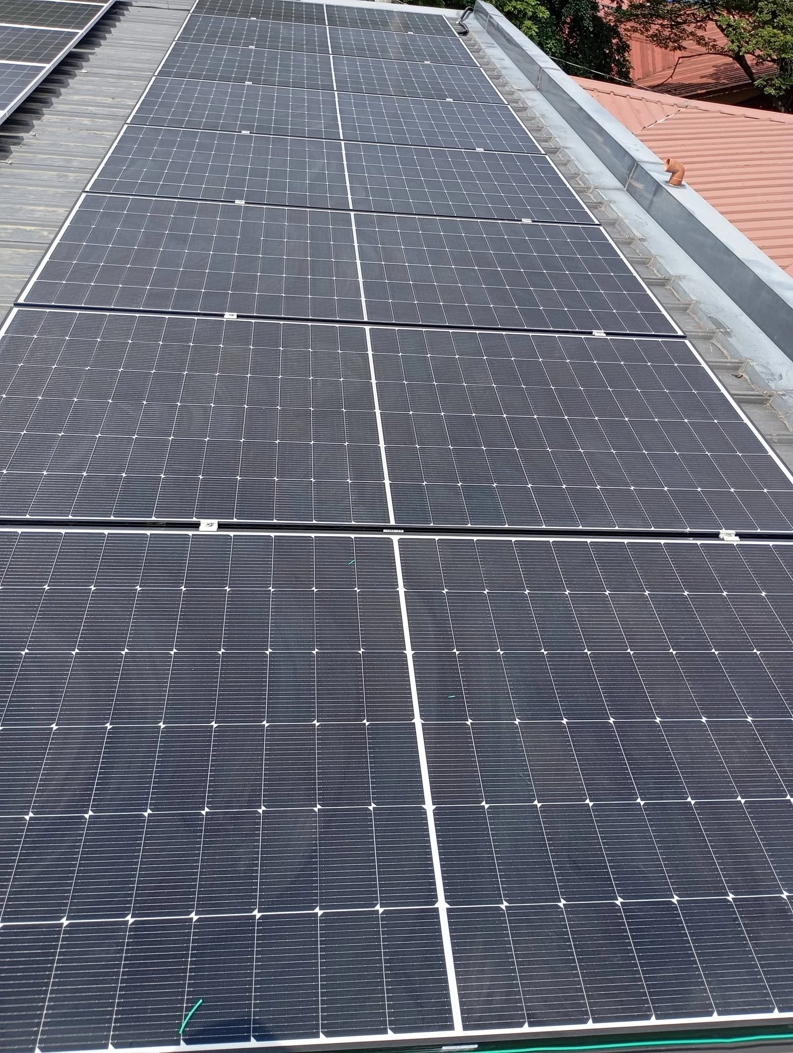A rooftop covered with multiple solar panels installed side by side.