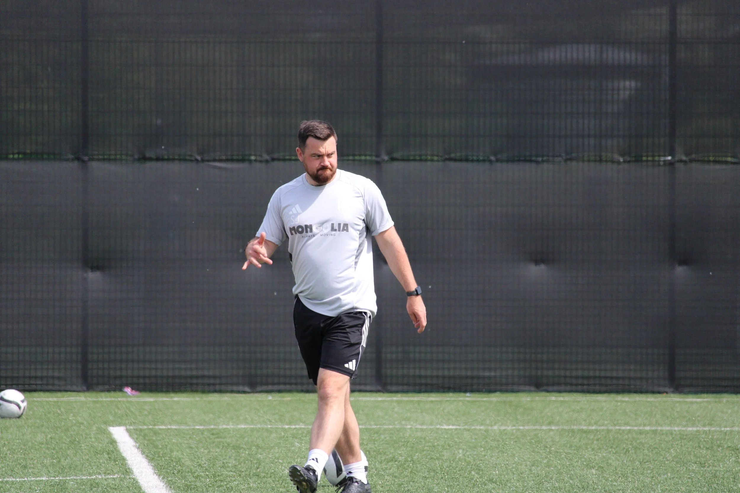 Steve Jaye, Fulham Women's manager takes a pre-match walk.