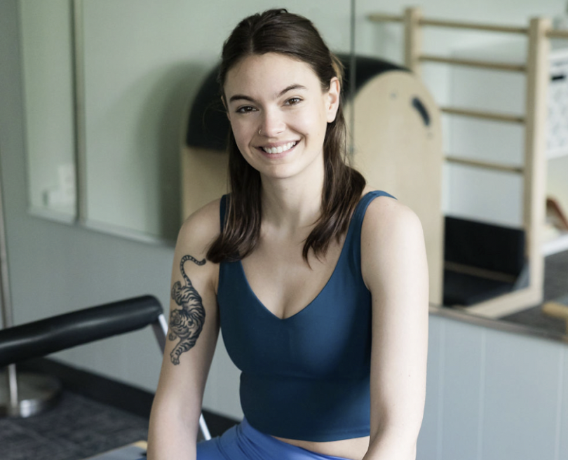 Pilates Plus instructor smiling in the studio