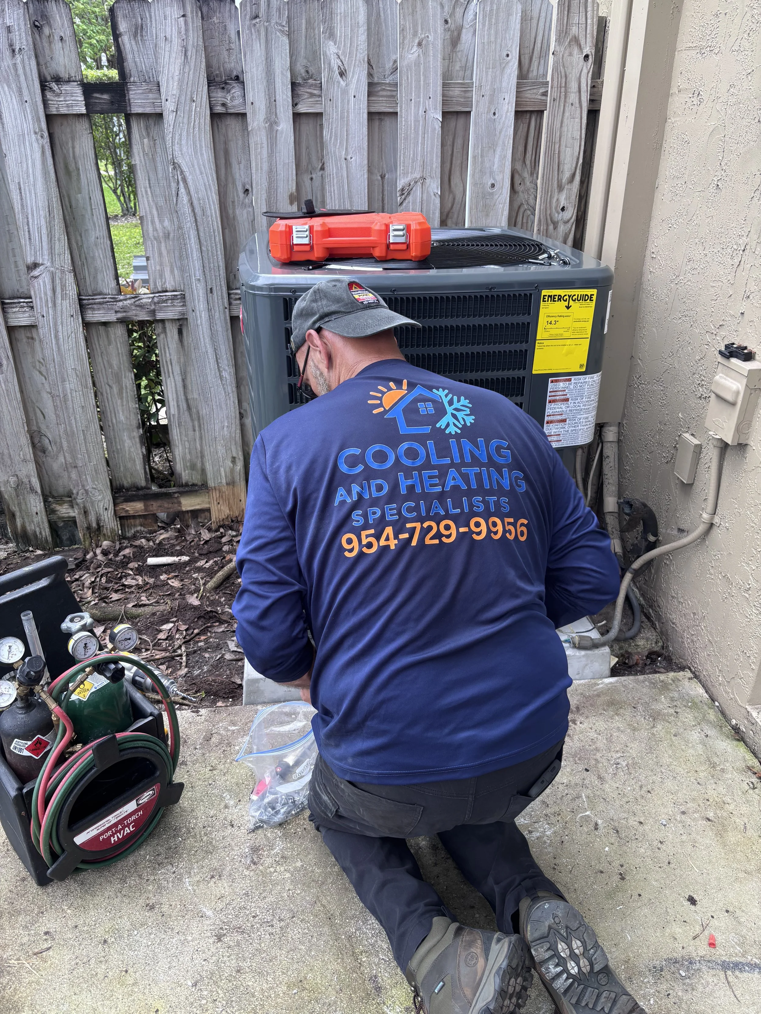 AC repair technician checking refrigerant levels Broward County Florida
