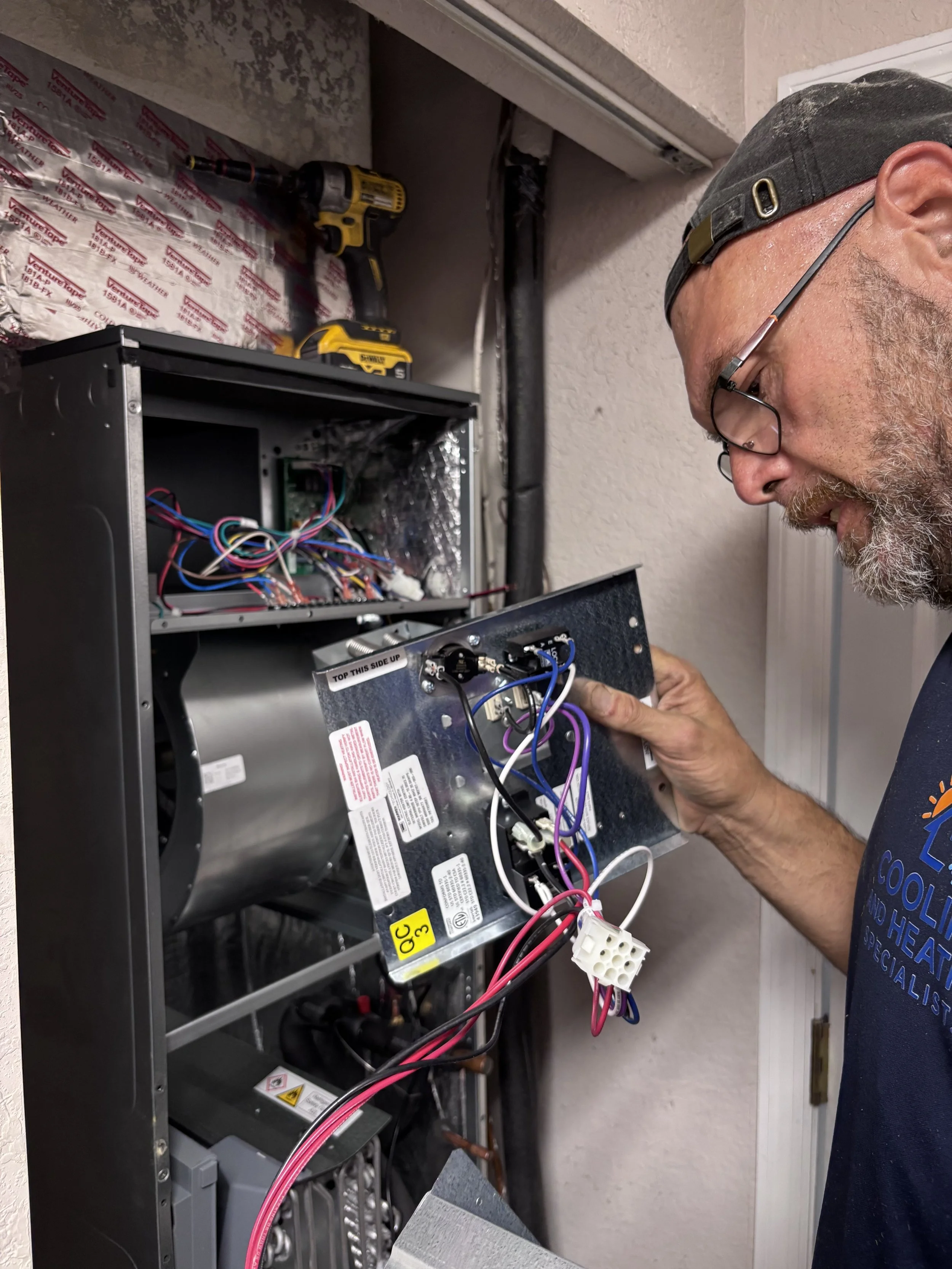 Licensed technician inspecting condenser unit Palm Beach County