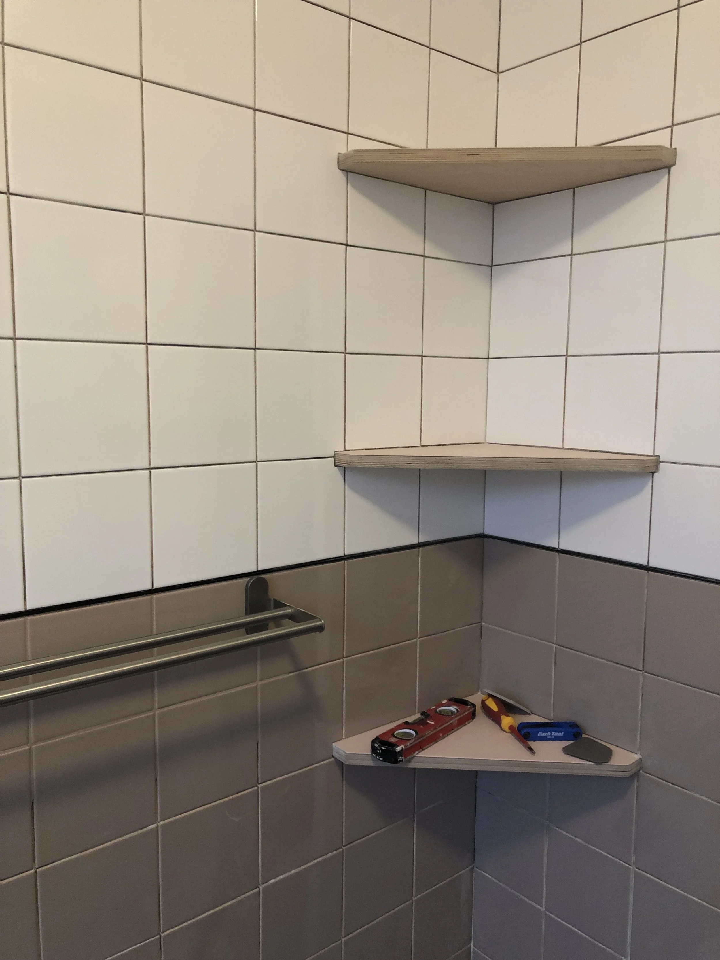 Bathroom tile in progress with custom ply recess shelves
