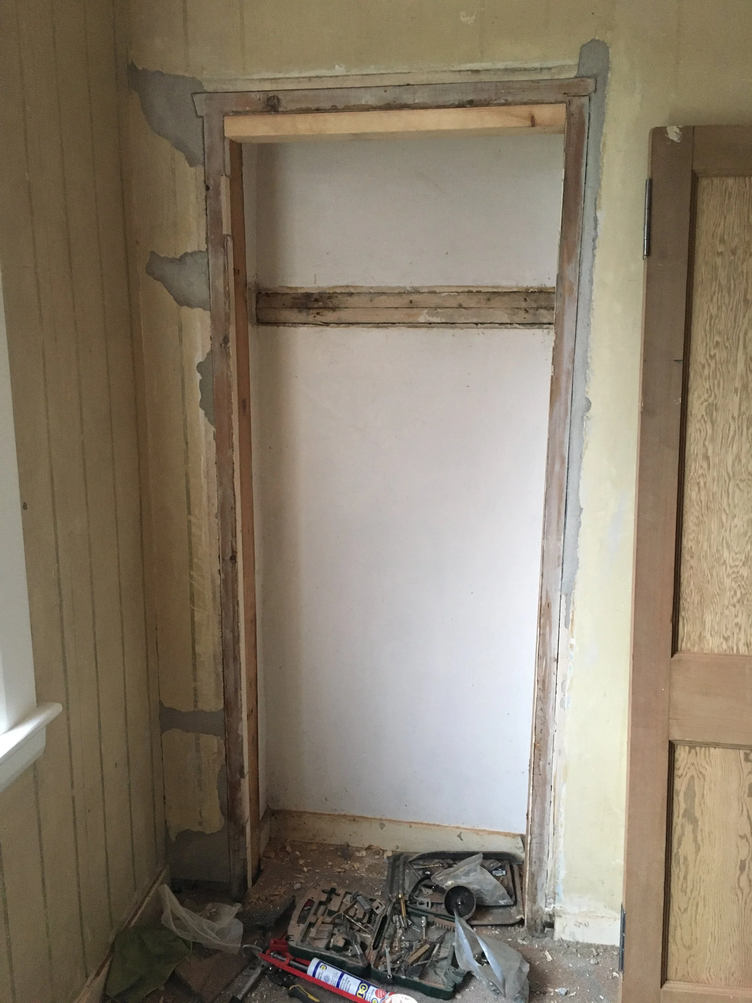 Matching a reclaimed pitch pine door to others in a house to cover this recess. Planed down to size, matching handle fitted and joinery made up to suit.