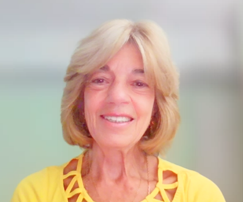 Smiling Lidia Durando use a yellow t-shirt , has light blond hair and brown/green eyes