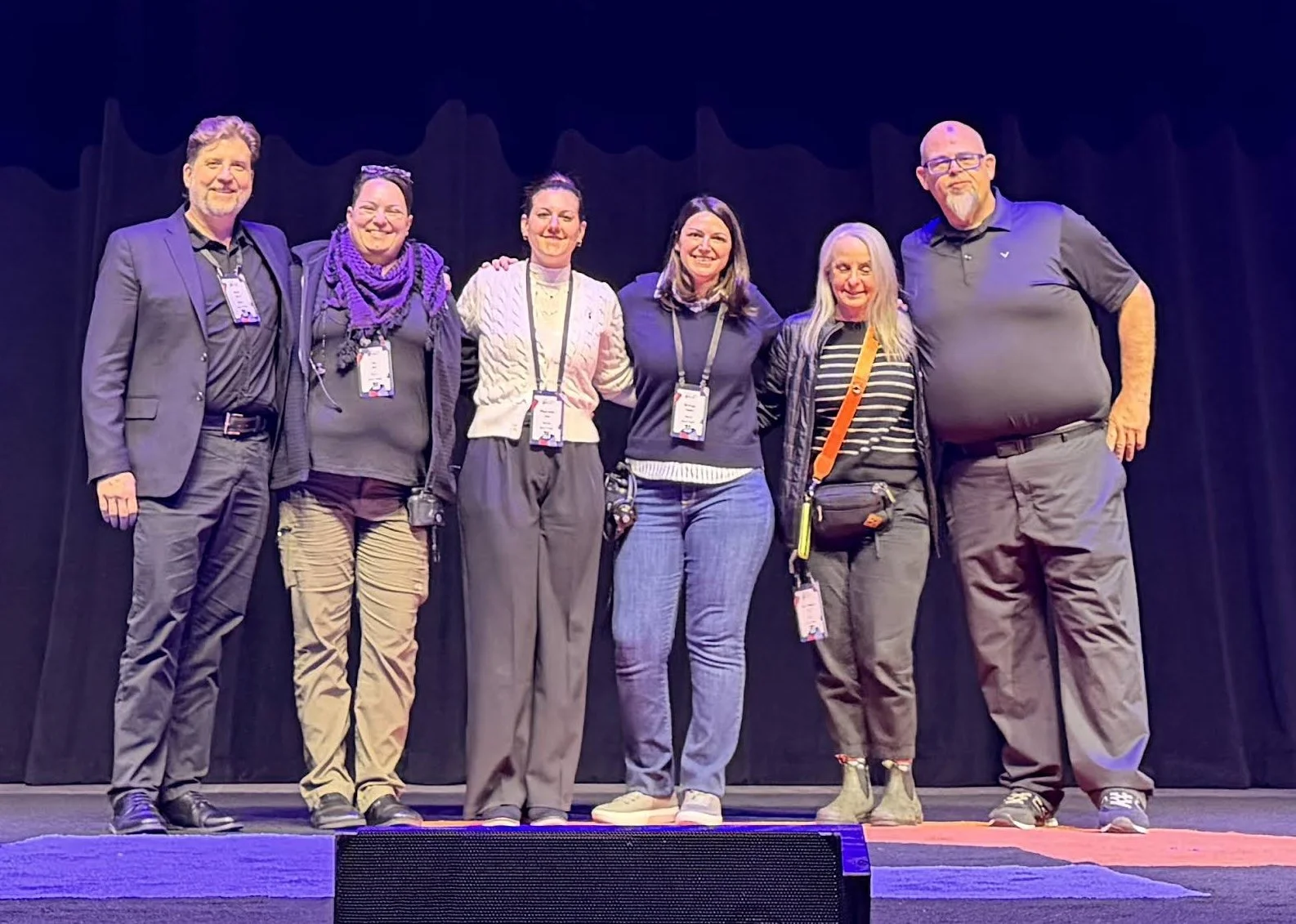 Experienced event production professionals gathered on stage, representing a trusted network of producers and event specialists.