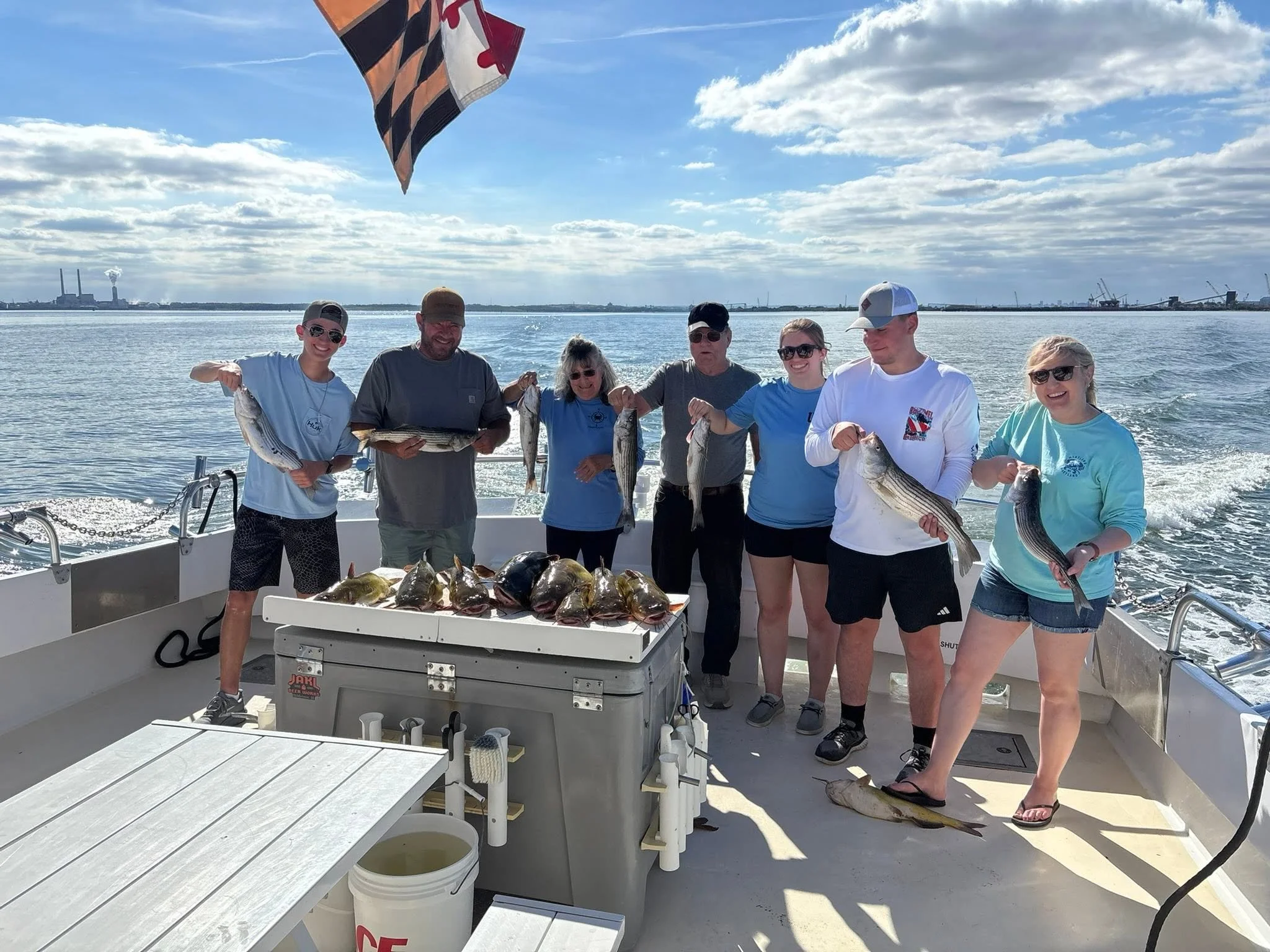 Group displaying their fishing catch on an Elligail Charters excursion
