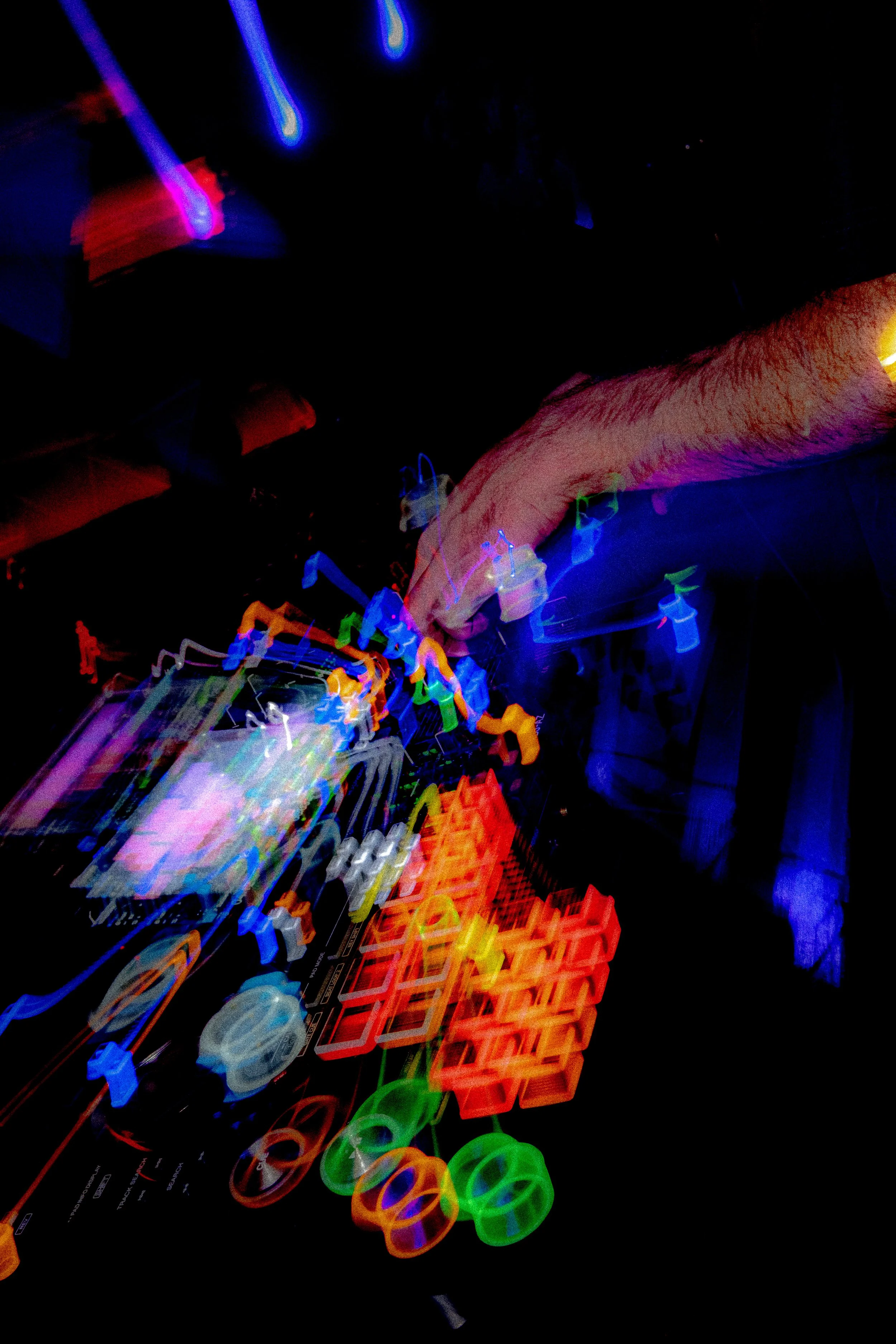 Colorful neon lights and shapes in motion, creating an abstract, vibrant scene.