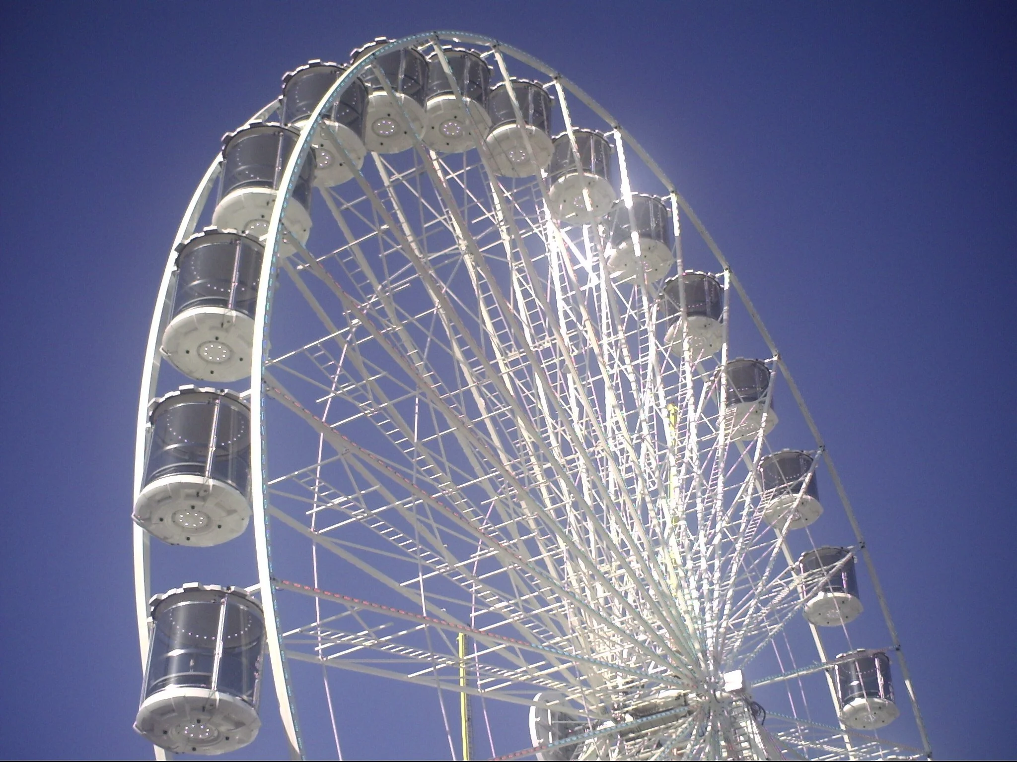 A large illuminated Ferris wheel against a dark night sky.