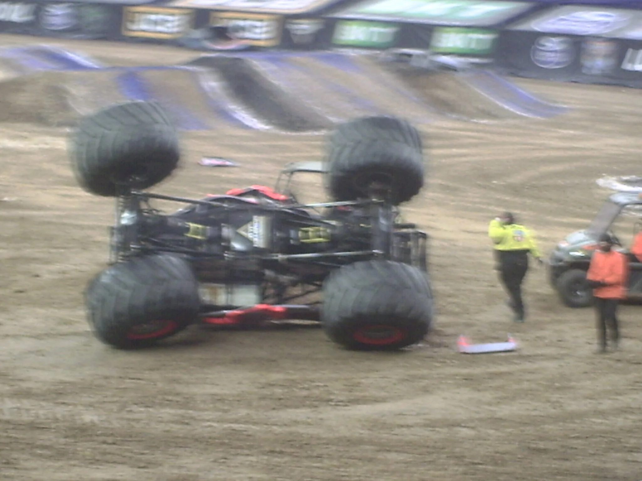 Blurred image of race cars on a dirt track at a racing event.
