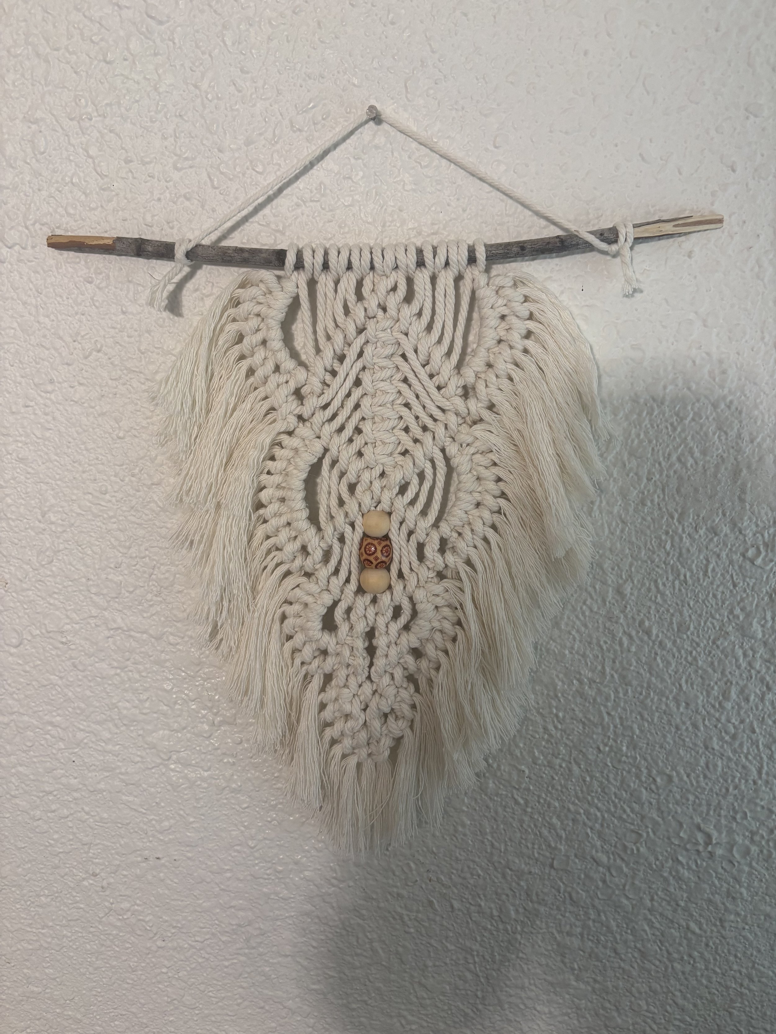 Oak & Rowan Leaf
(10" x 13")
Inspired by the shape of a forest leaf, this piece combines flowing fringe, textured details, and natural wood accents to create a warm, organic focal point.
$80.00