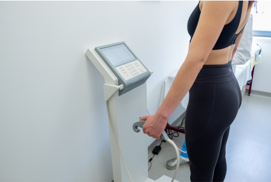 Woman using a body composition analyzer