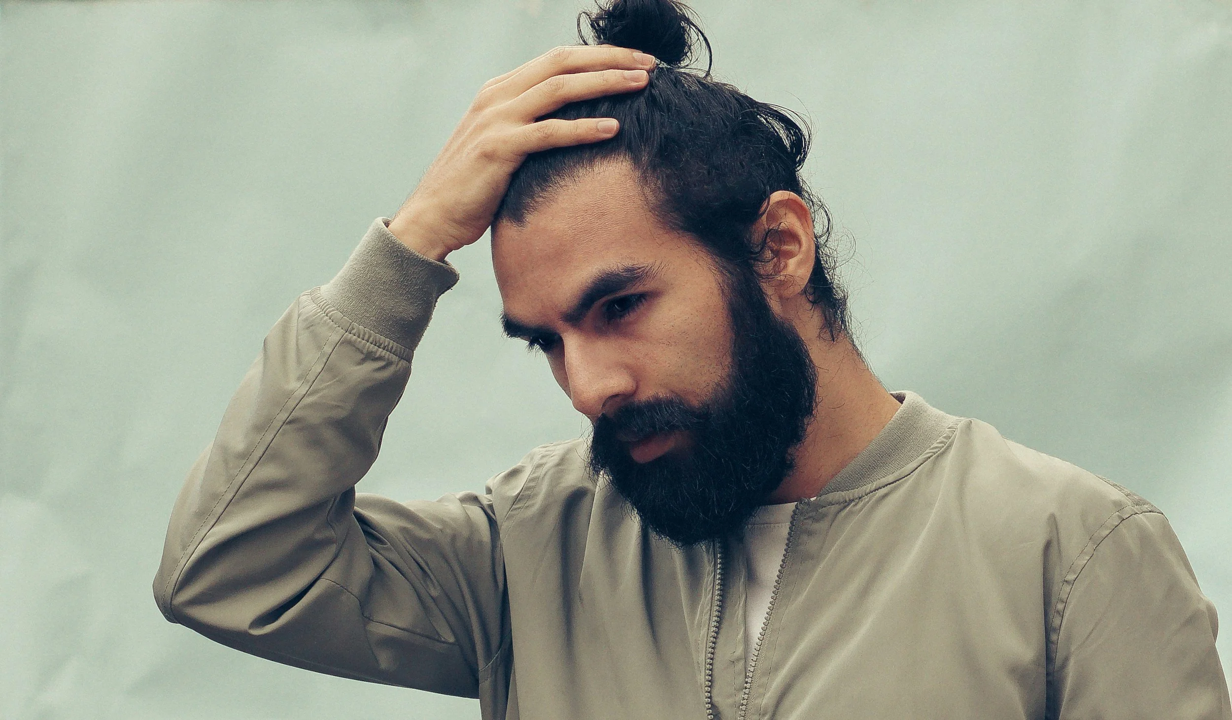 Man examining his hairline for signs of thinning